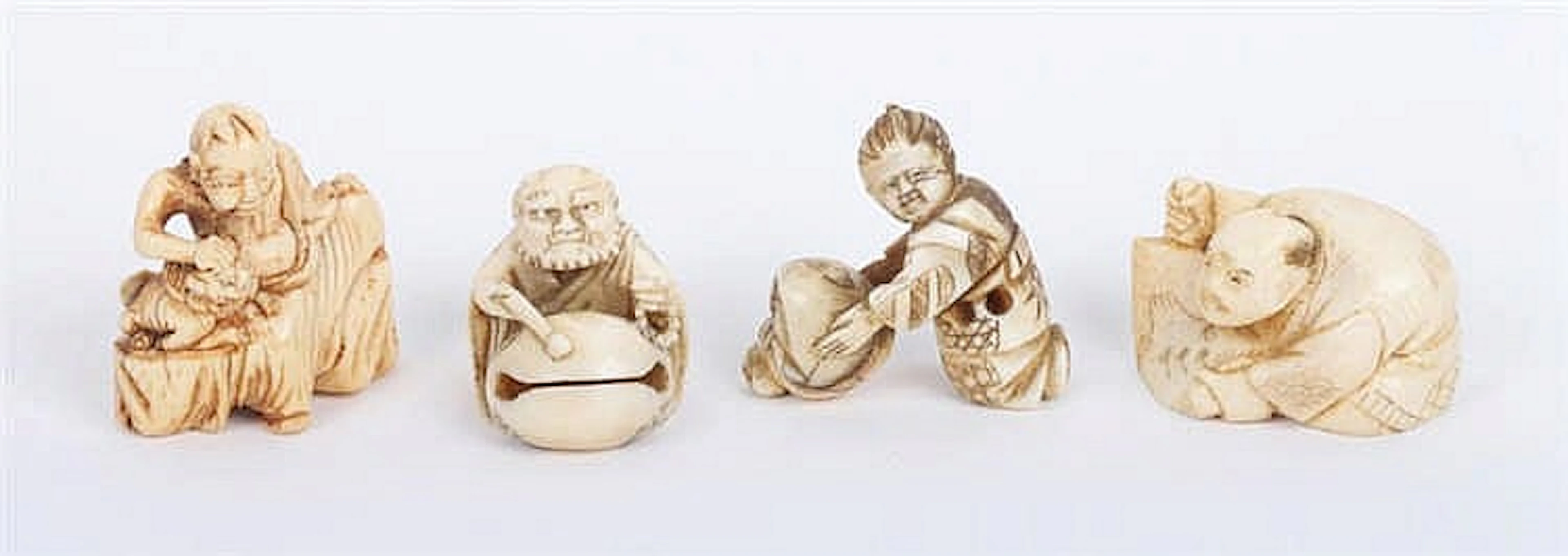 A GROUP OF FOUR JAPANESE VINTAGE IVORY NETSUKES