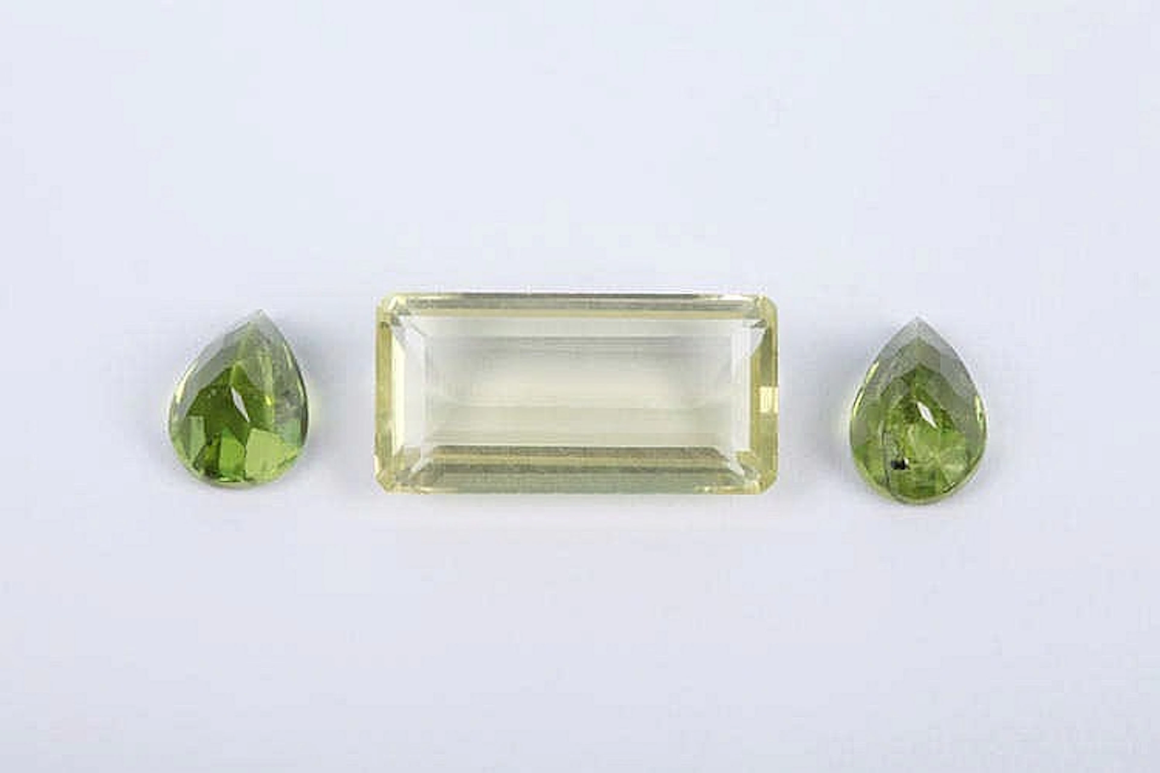 A CITRINE AND TWO PERIDOT GEMSTONES