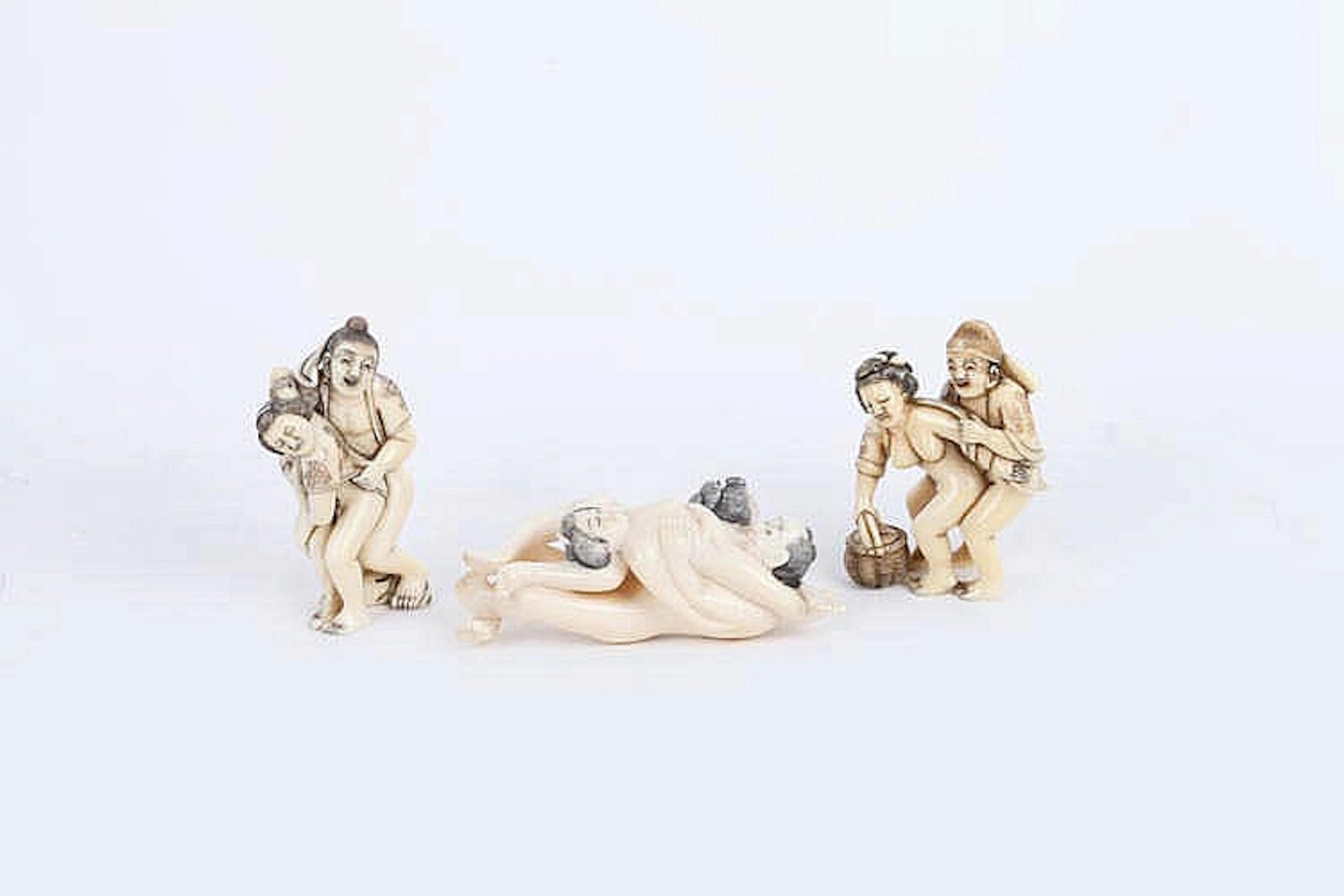 A GROUP OF THREE JAPANESE VINTAGE IVORY NETSUKES