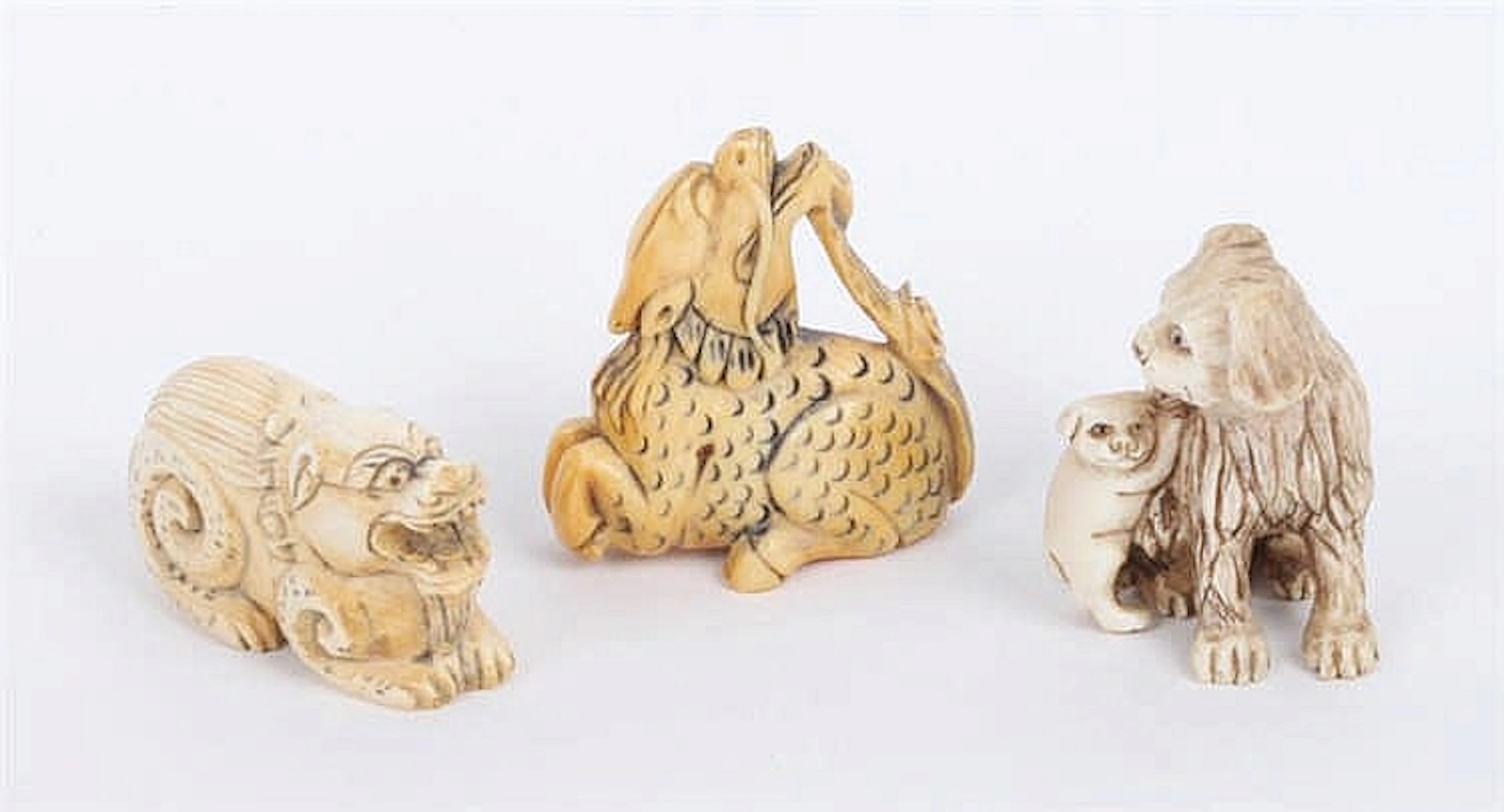 A GROUP OF THREE JAPANESE AND CHINESE IVORY NETSUKES