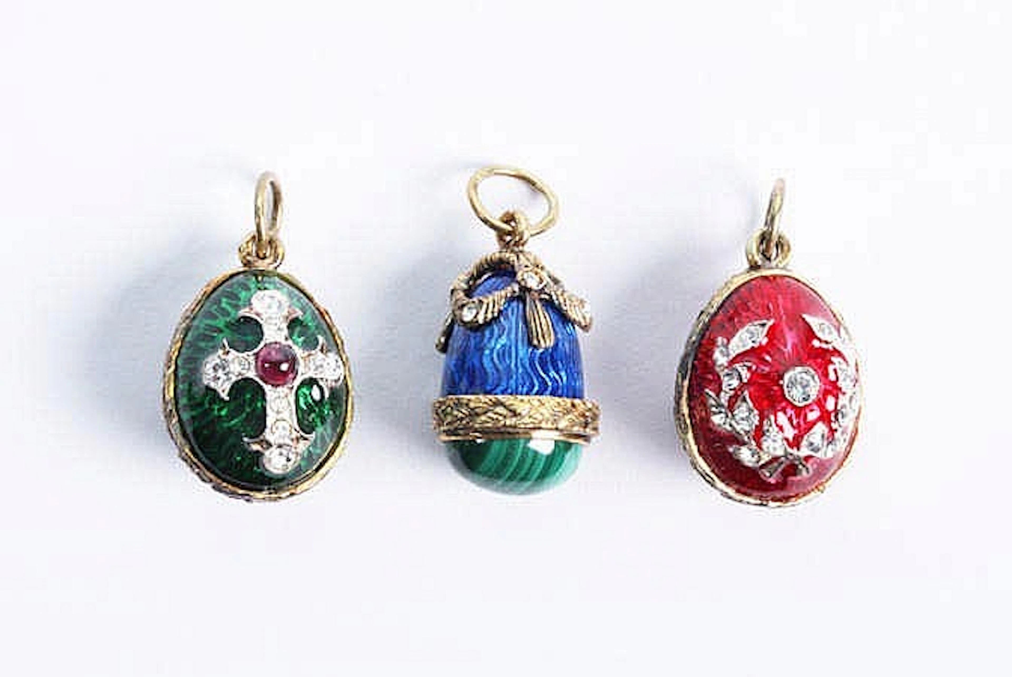 A COLLECTION OF THREE ENAMEL, ZIRCON AND MULTI-COLORED GEMSTONE PENDANTS