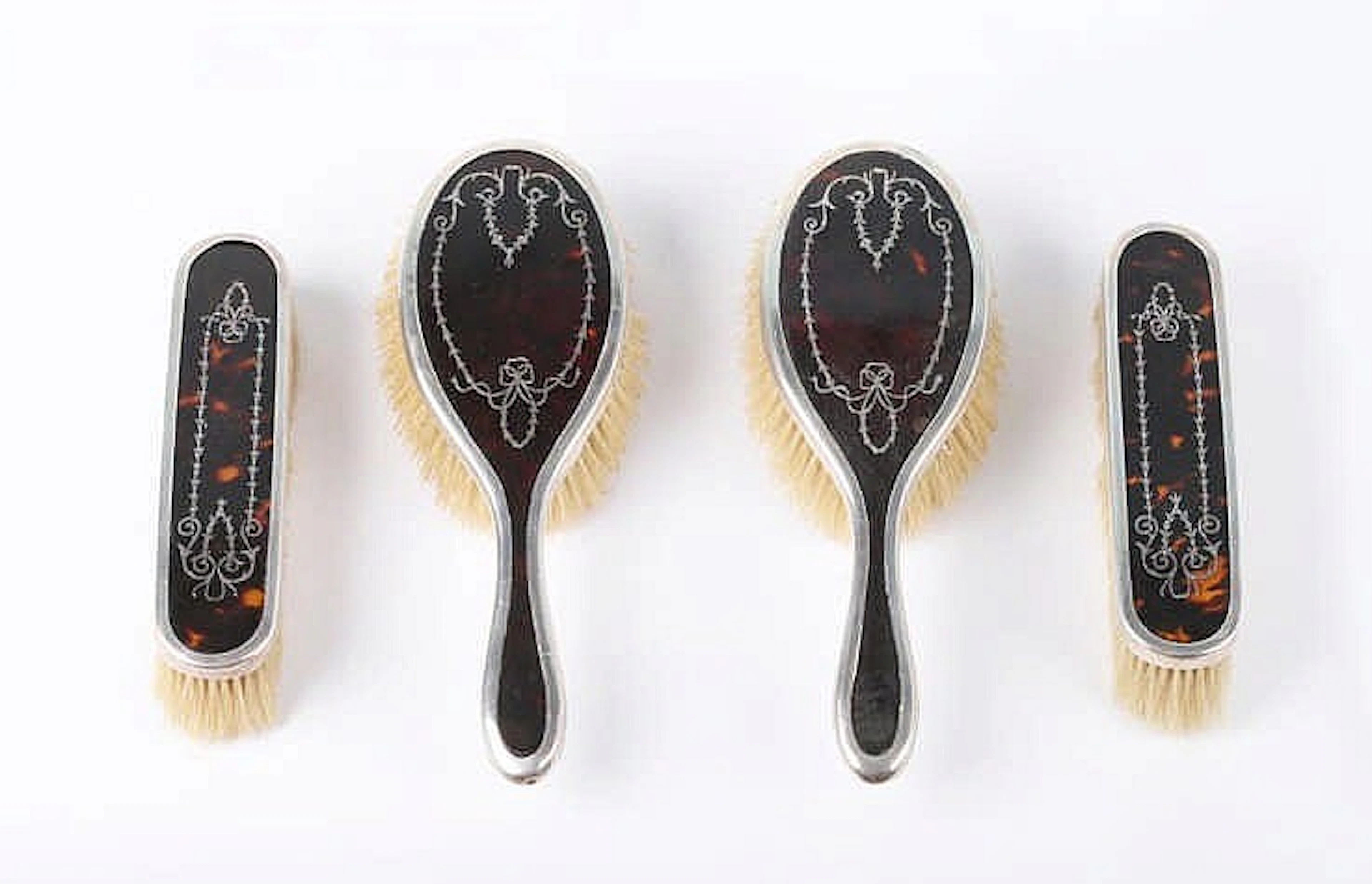 AN ANTIQUE ENGLISH STERLING SILVER AND TORTOISESHELL DRESSING TABLE SET