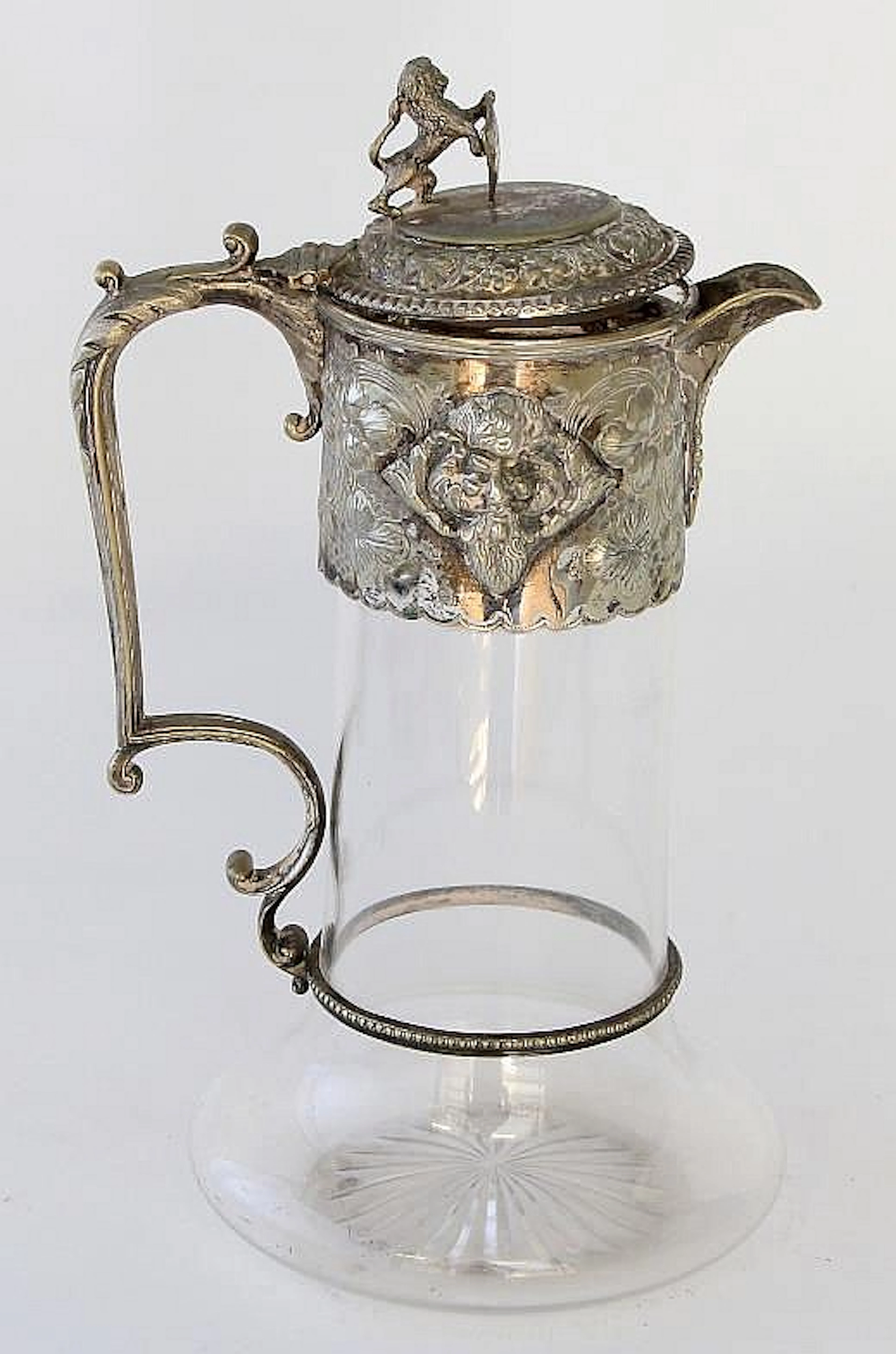 A silver plated claret jug The plain glass jug of