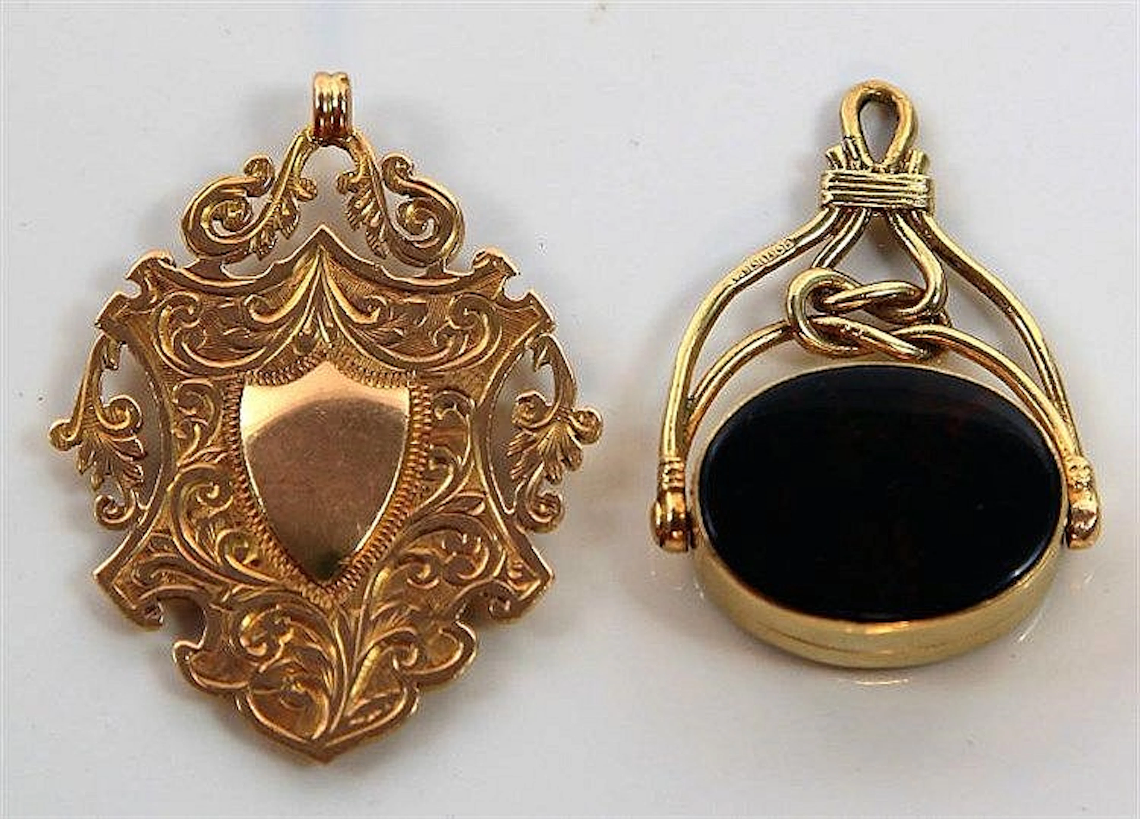 A 9ct gold pocket watch fob of oval form Having pi