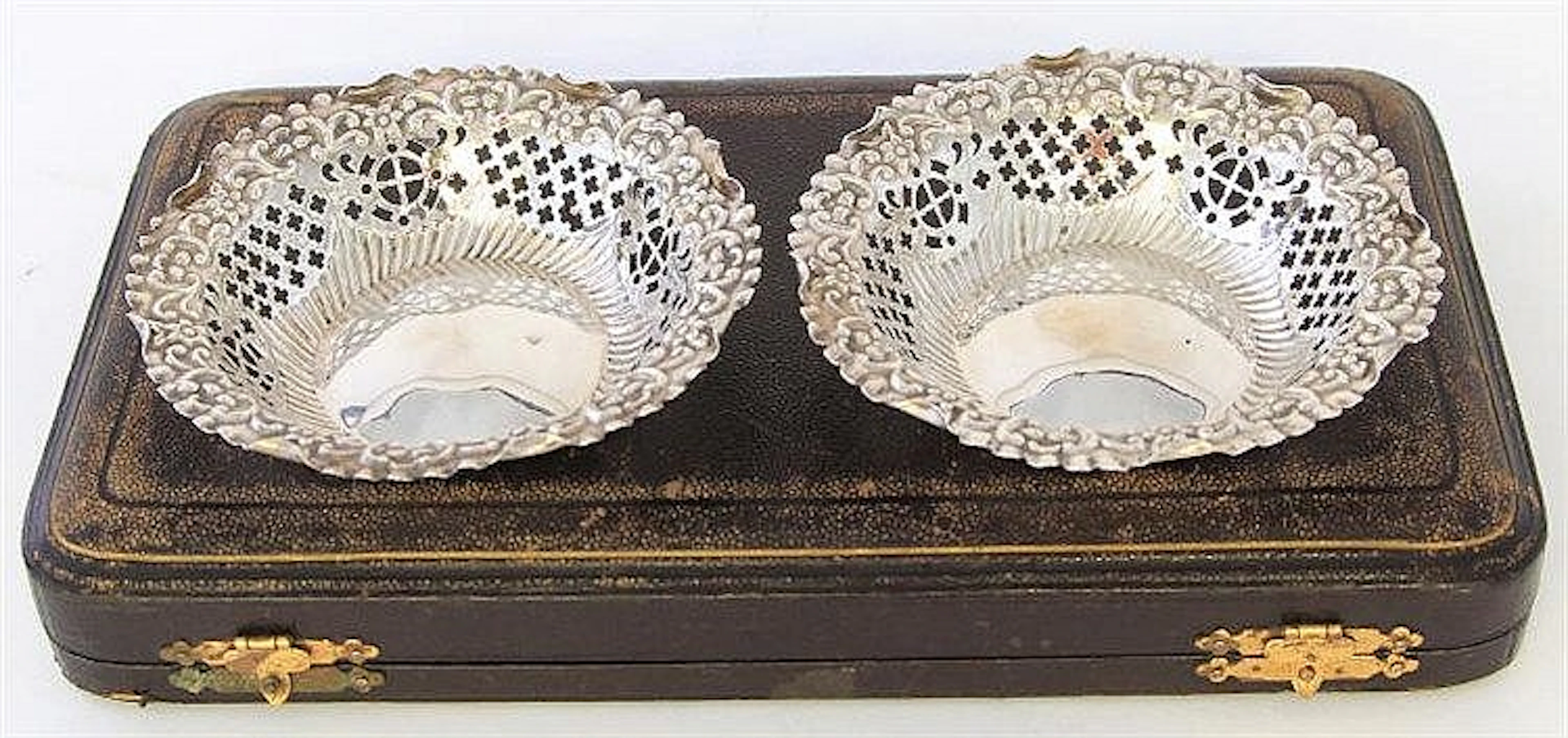 A silver pair of bon-bon dishes Of pierced circula