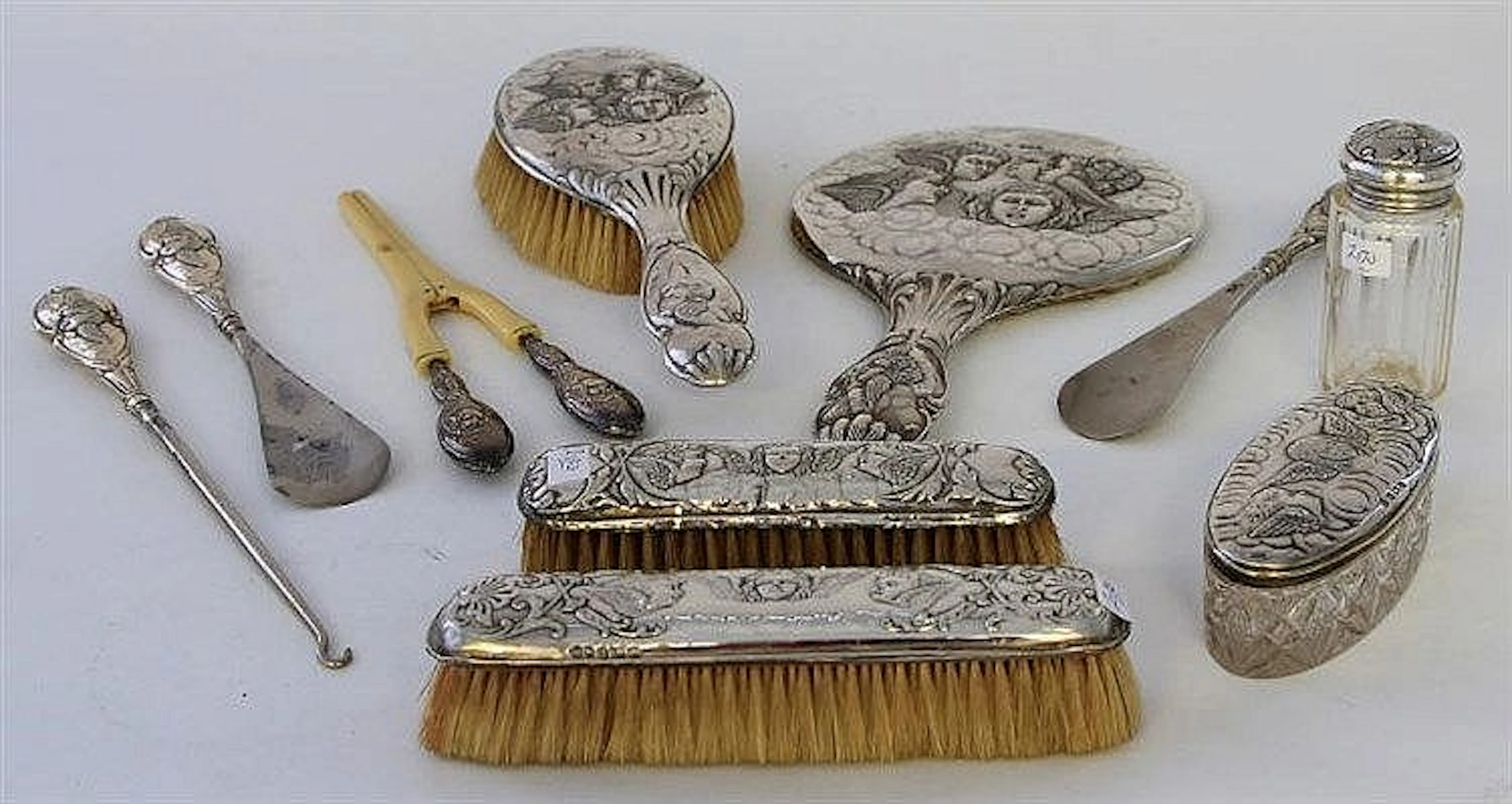 An Edwardian silver dressing table set Embossed an