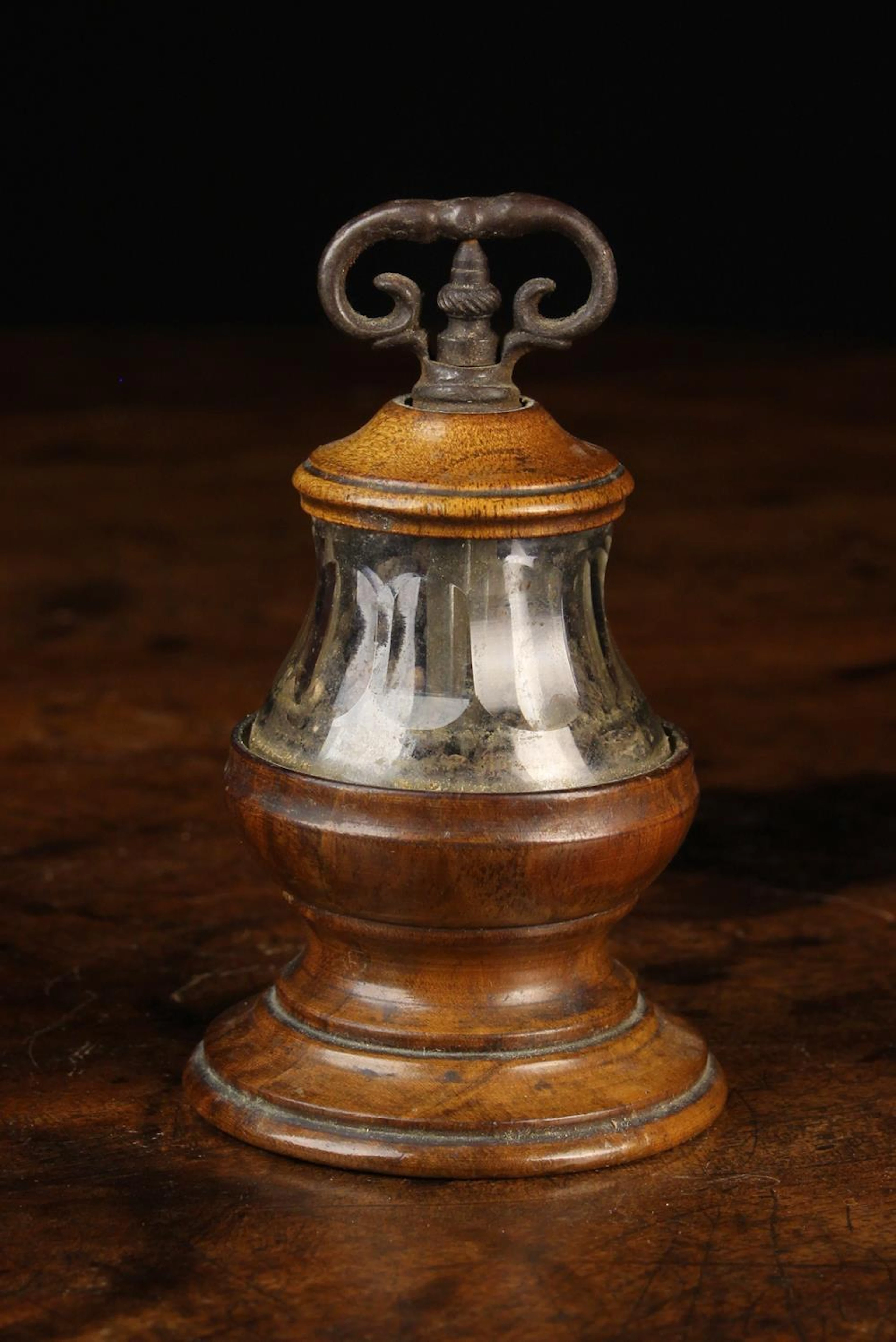 An Antique Treen Pepper Grinder with a clear fluted glass...