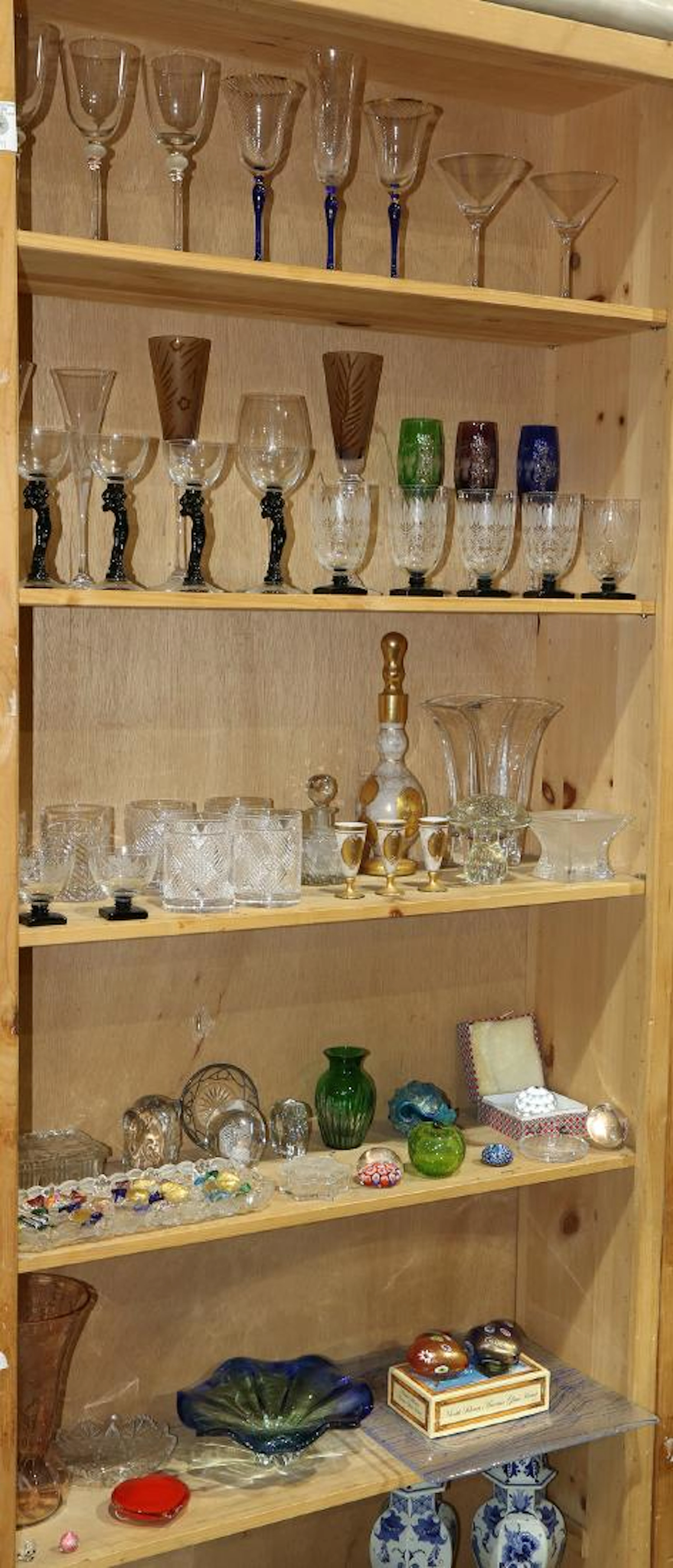 Five shelves of associated barware and glassware