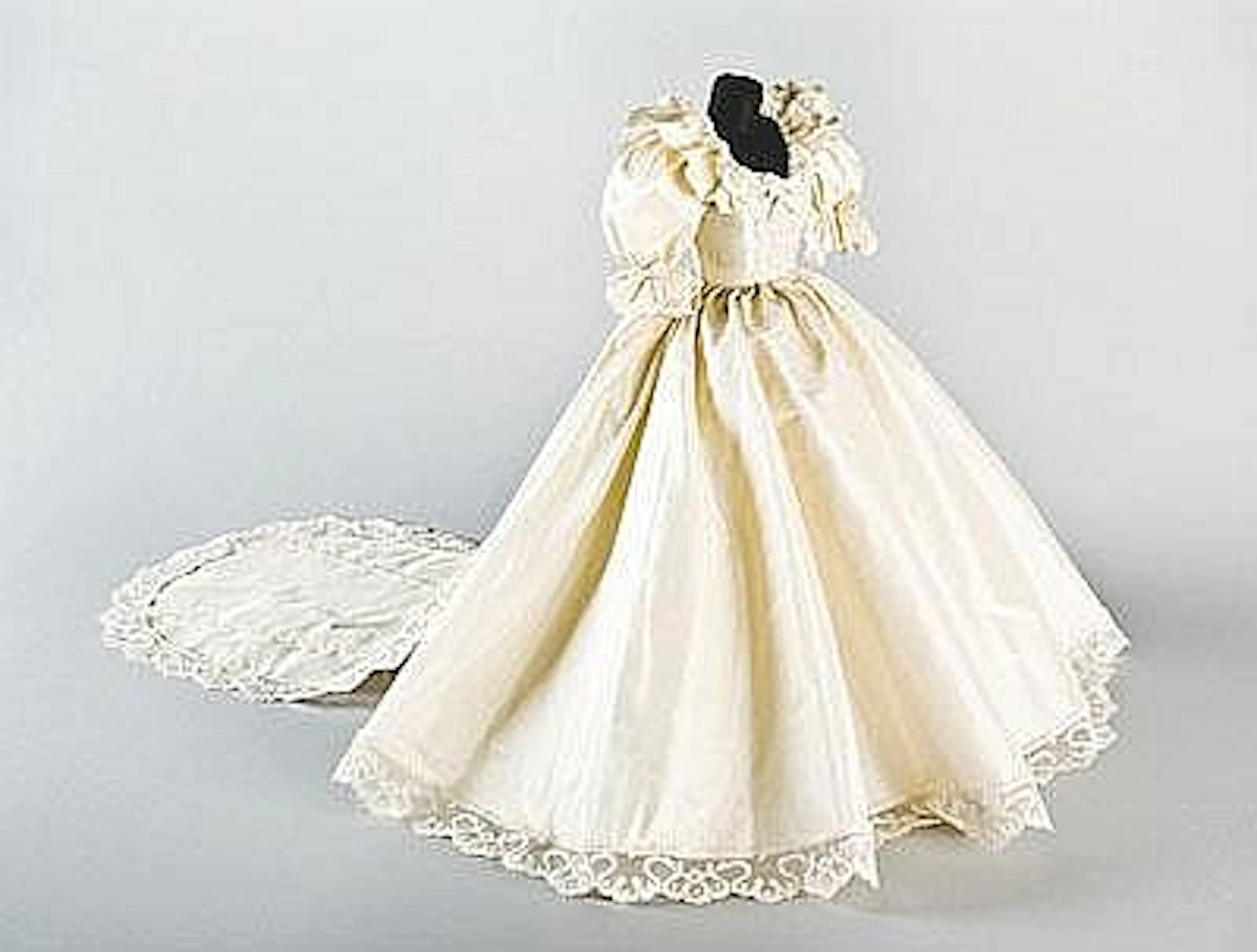A miniature copy of the royal wedding gown and