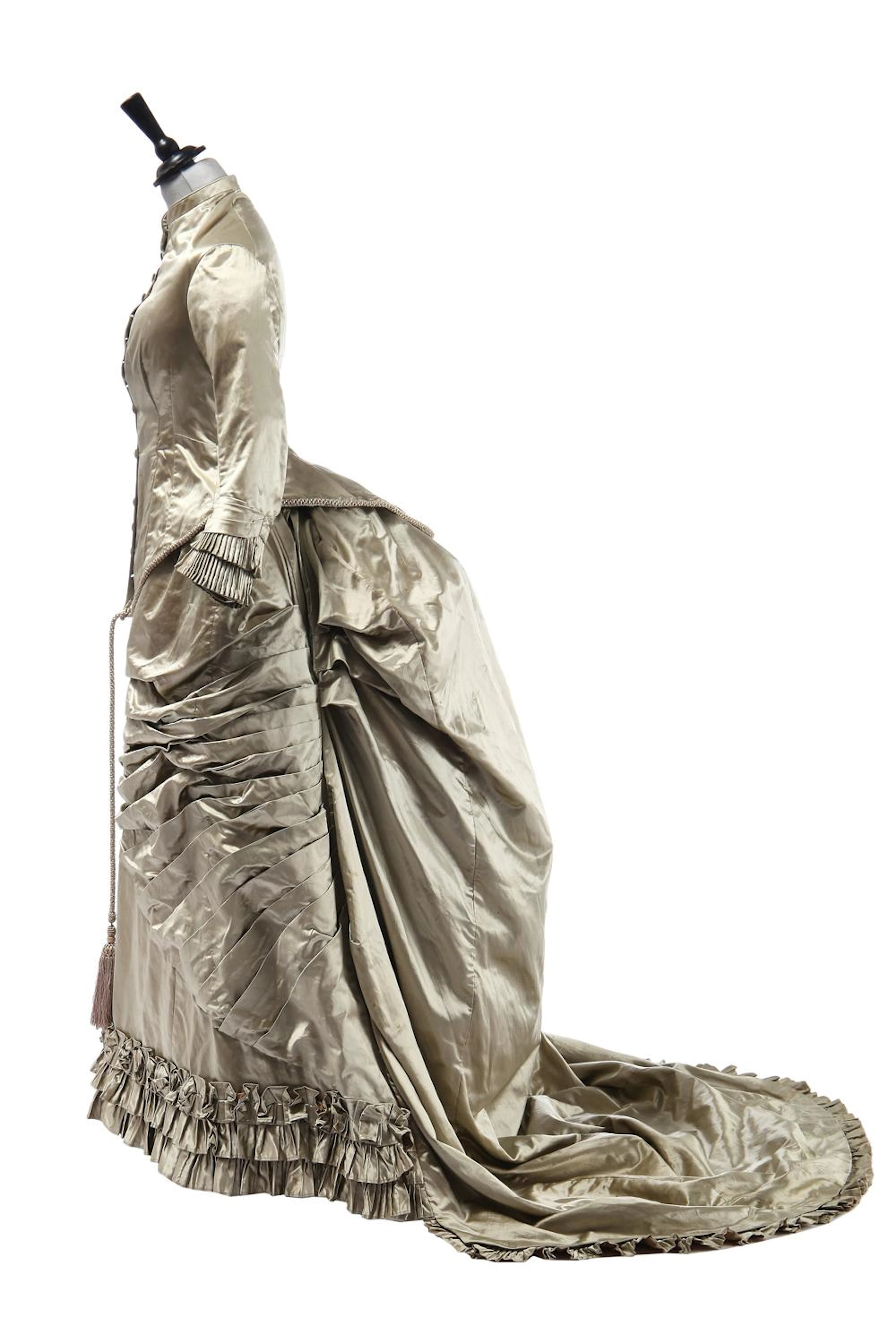 A champagne-green satin bridal gown, circa 1880,