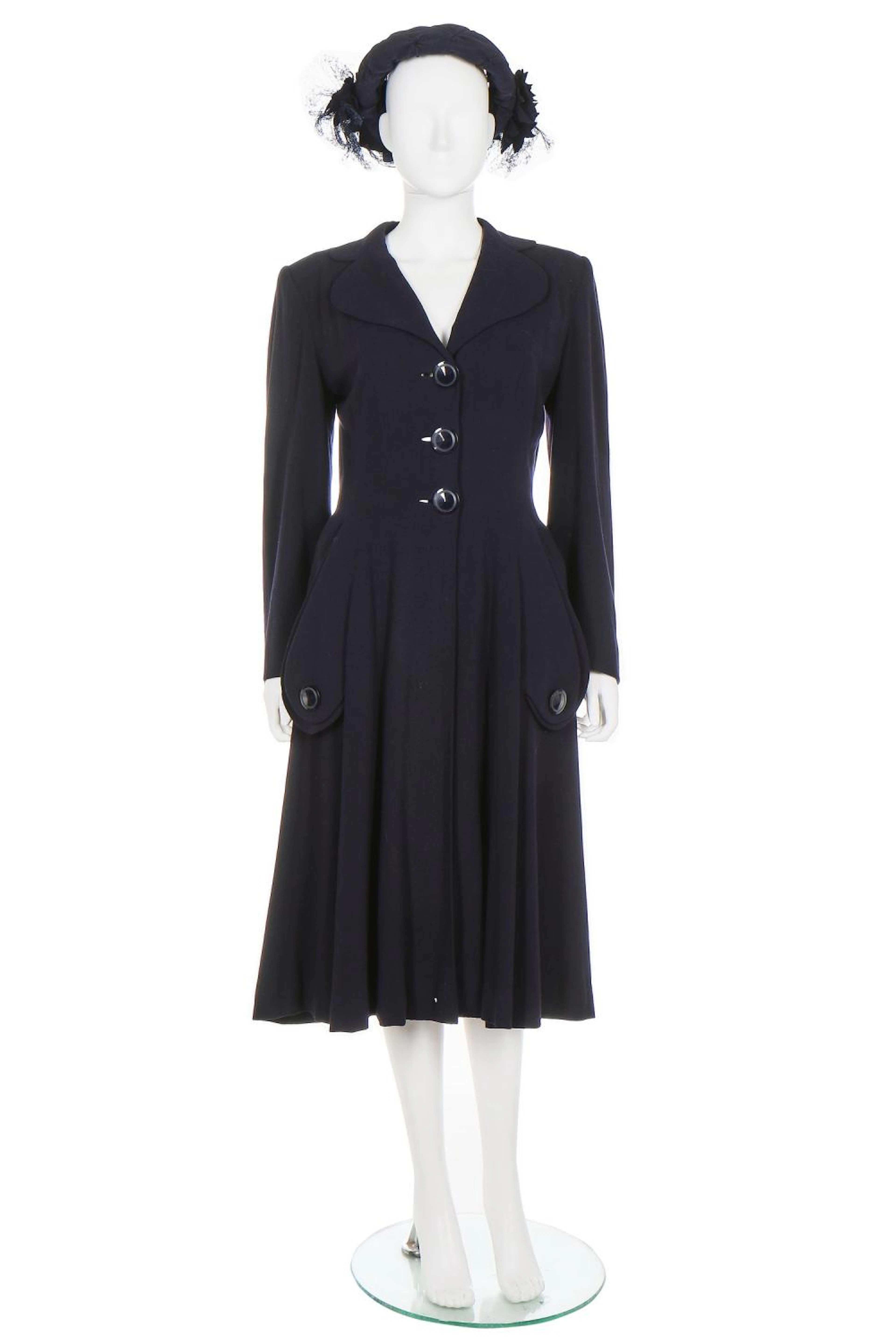 A Norman Hartnell couture navy wool coat, 1948, labelled, fitted waist with