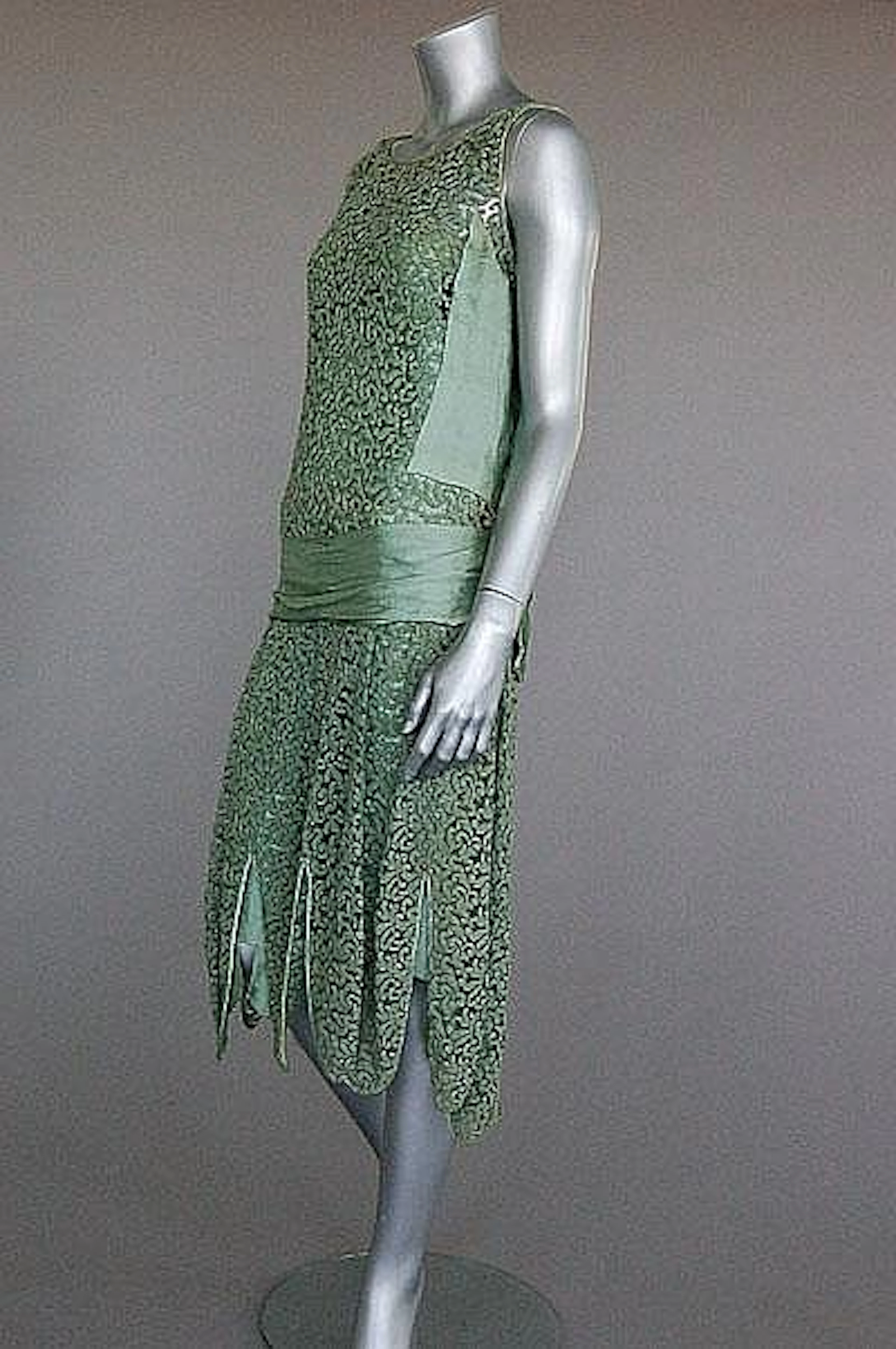 A Jeanne Paquin labelled green lace and satin