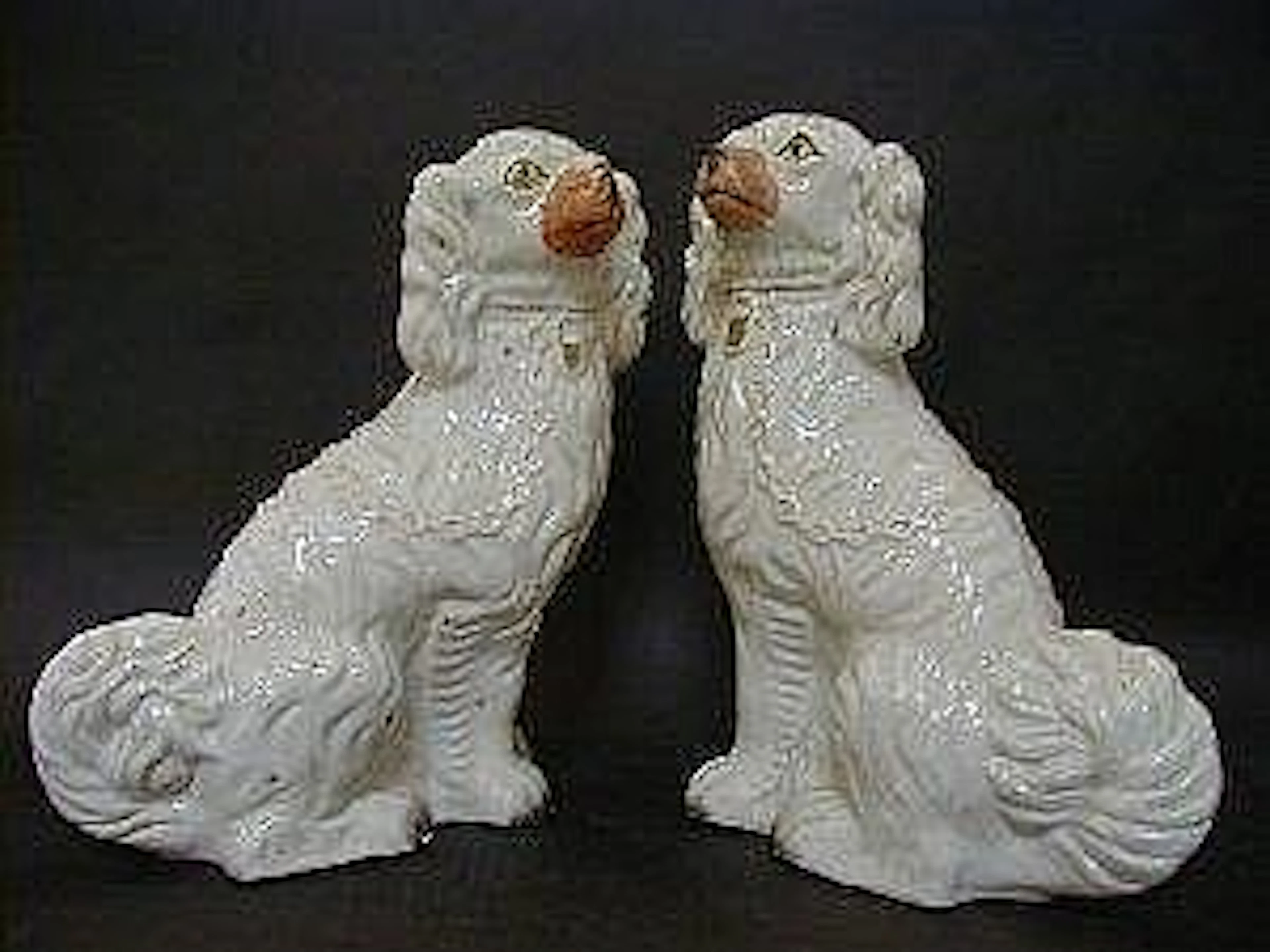 A NEAR PAIR OF STAFFORDSHIRE CHIMNEY SPANIELS