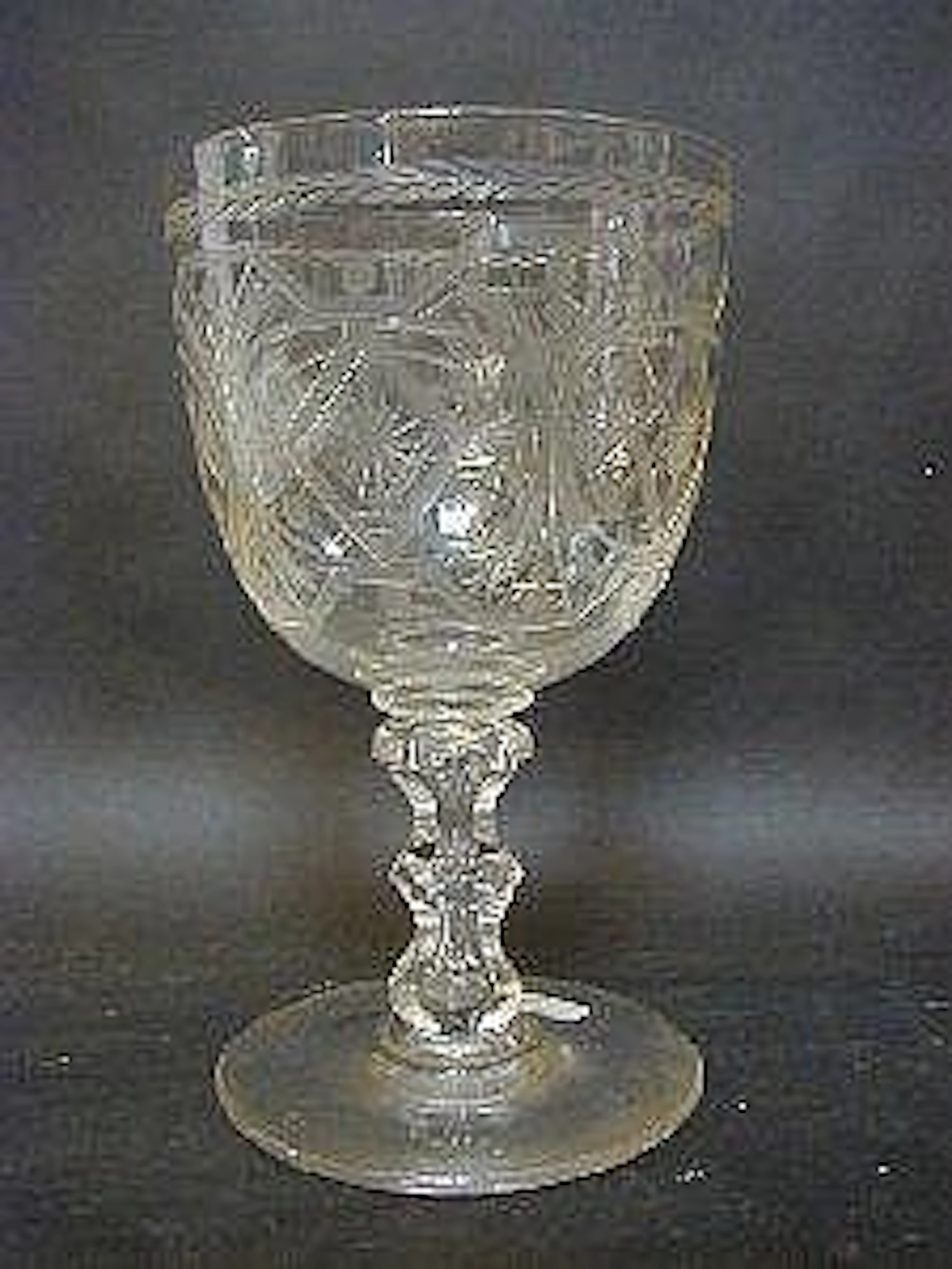 A MID VICTORIAN ENGRAVED GLASS GOBLET, on facet cut stem, height 22cm