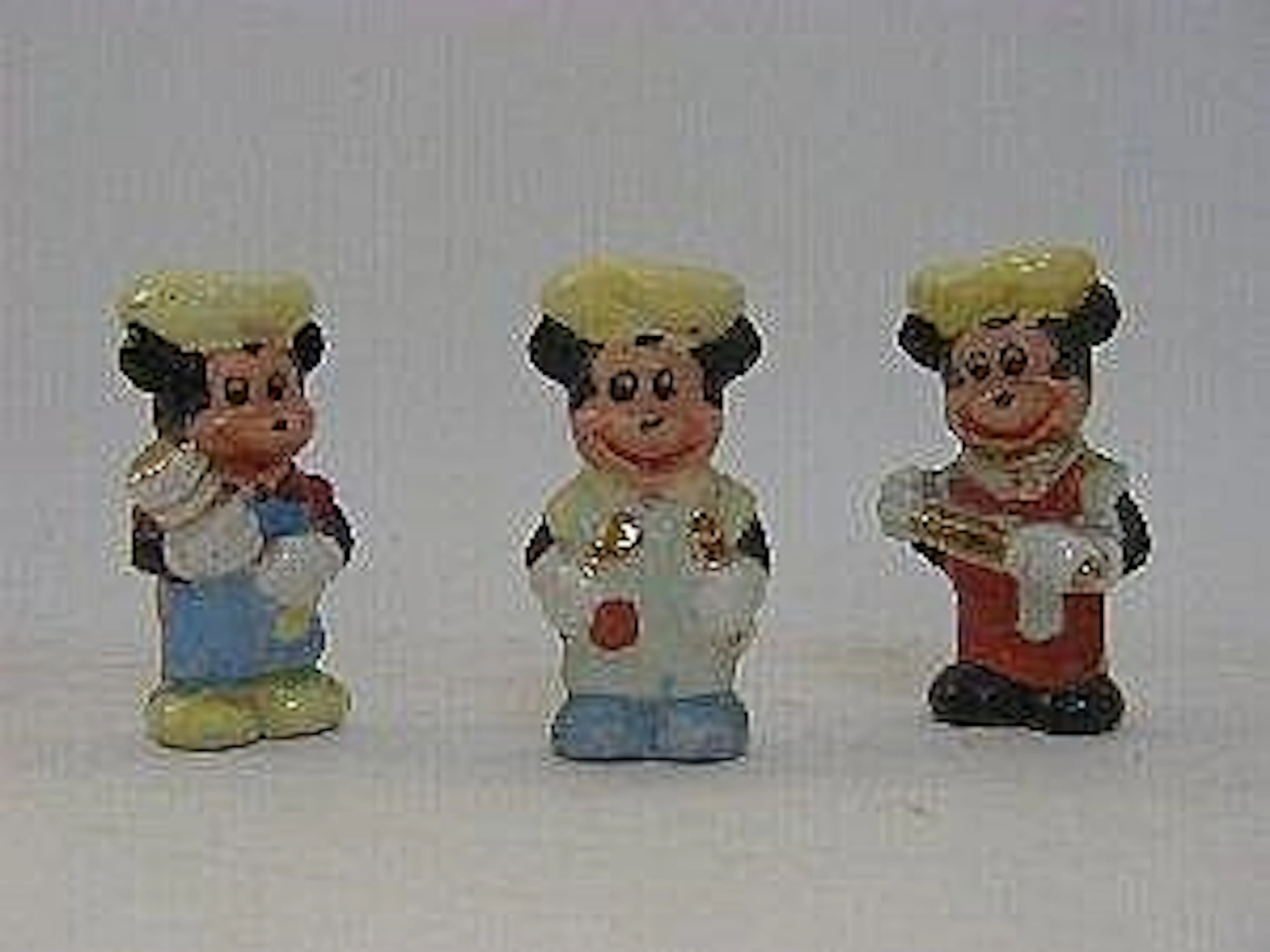 A SERIES OF THREE CERAMIC MICKEY MOUSE FIGURES