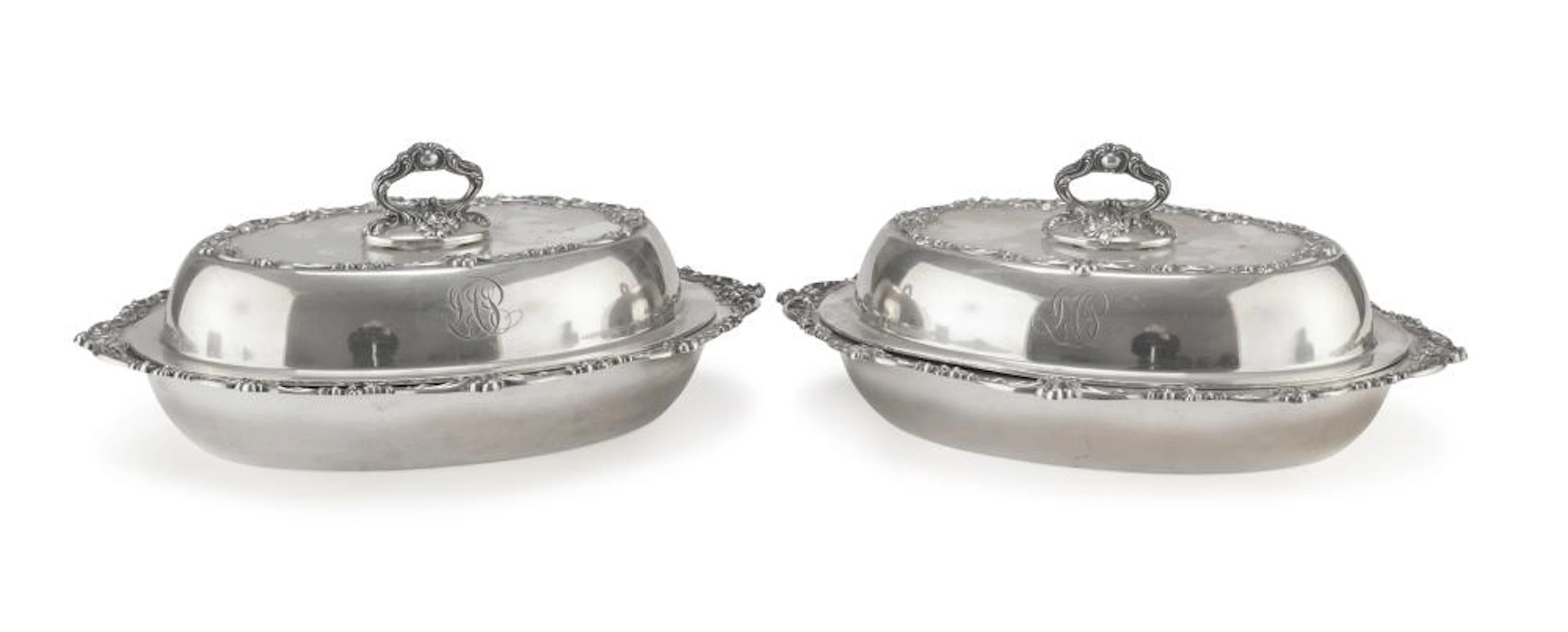 A PAIR OF COVERED VEGETABLE DISHES IN SILVER