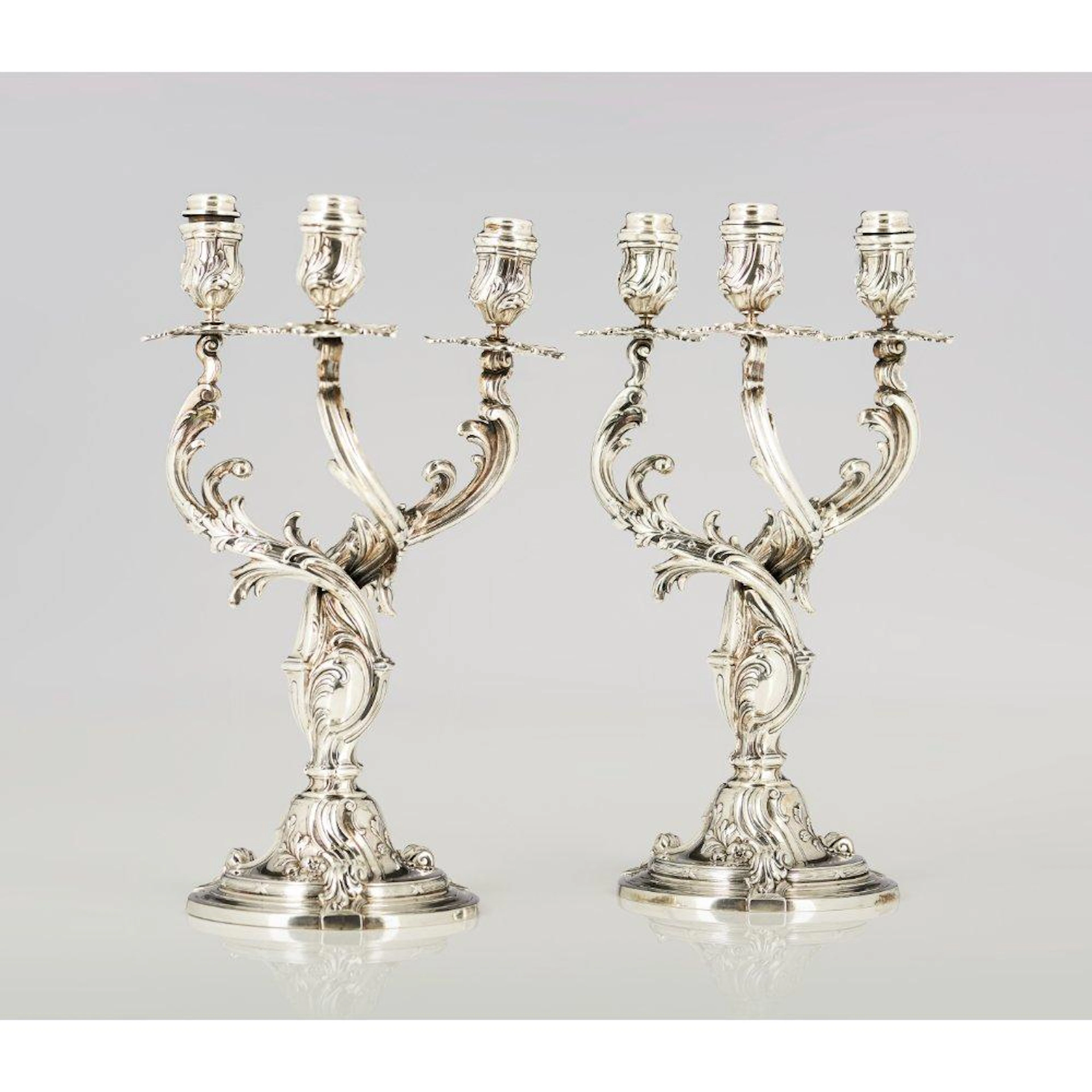 A pair of three branch candelabra after a prototype by...