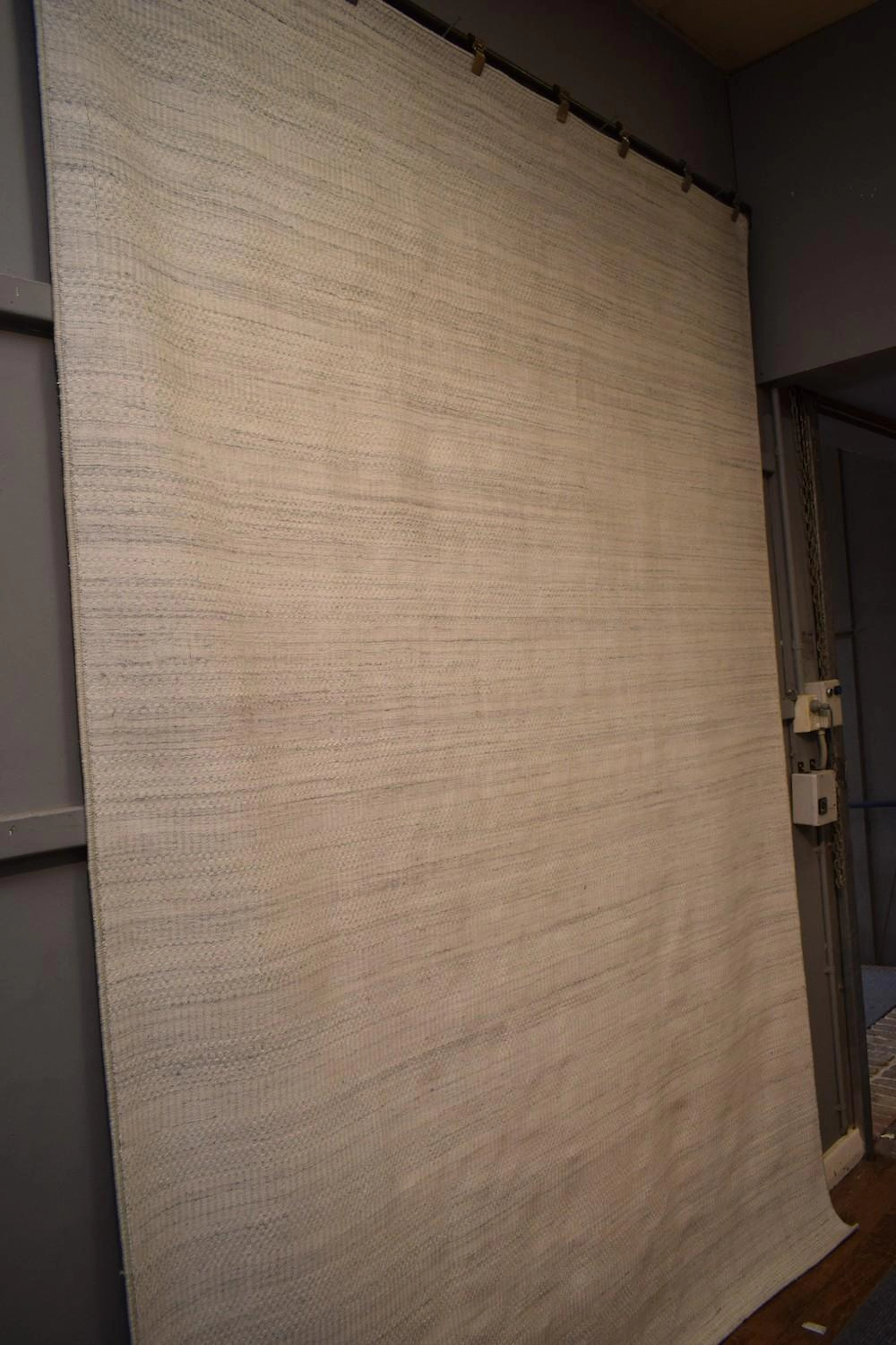 A MODERN IVORY & GREY-TONED CARPET