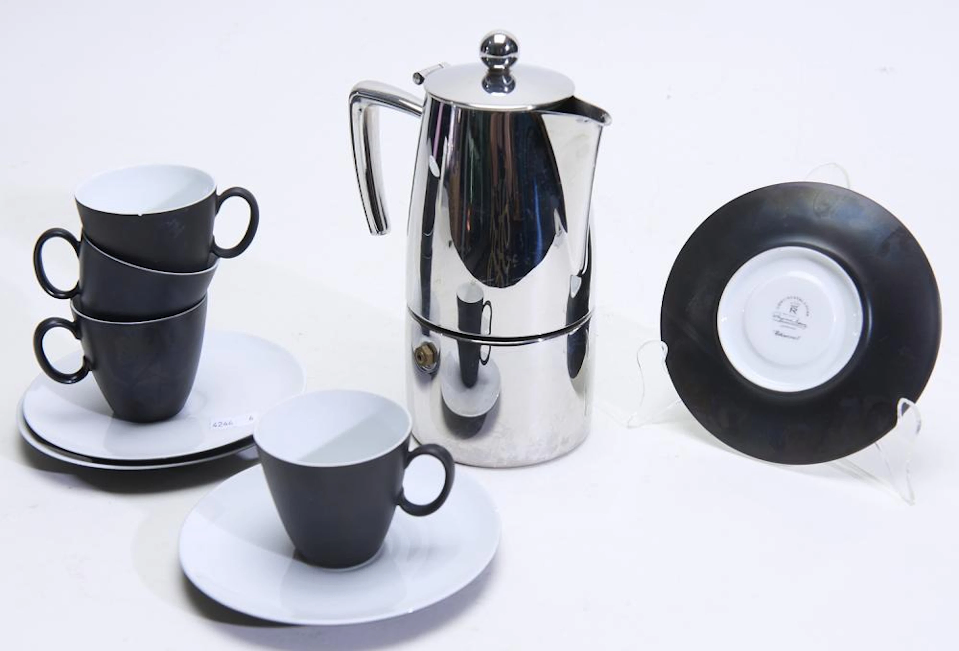 AN ITALIAN STOVETOP COFFEE MAKER AND FOUR ESPRESSO CUPS...