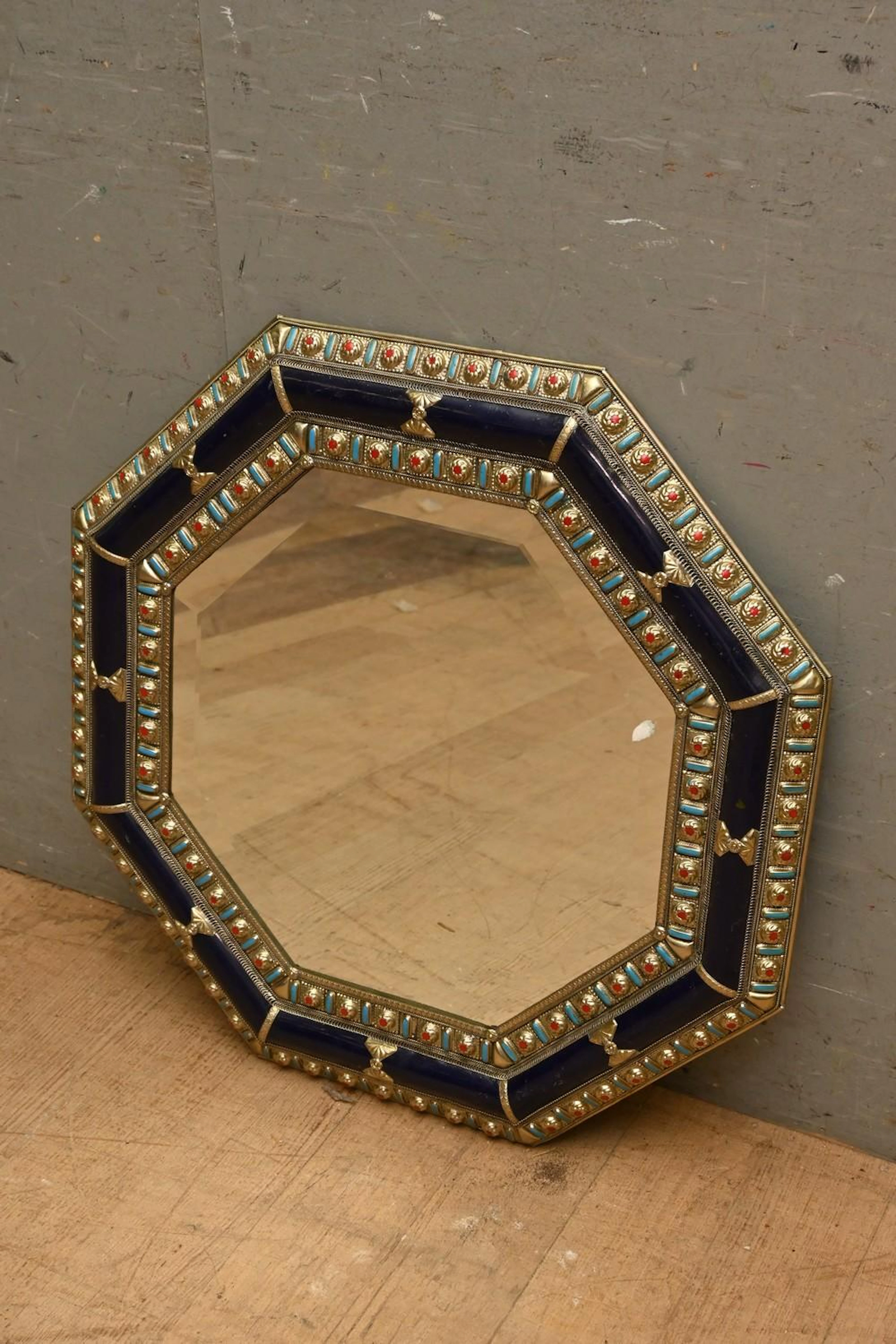 AN OCTAGONAL MOROCCAN PRESSED METAL MIRROR ( 65H X 65W...
