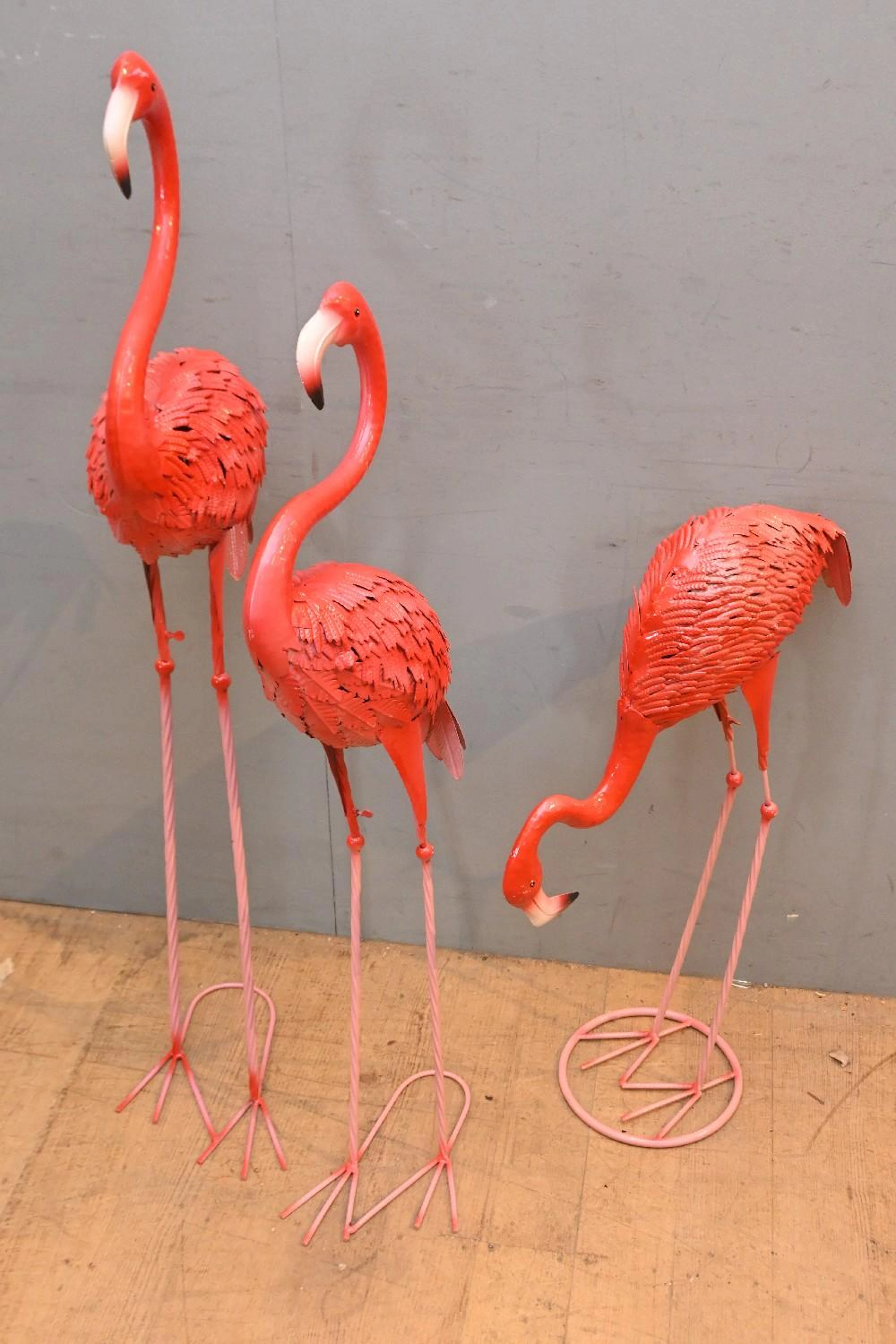 A SET OF THREE METAL GARDEN FLAMINGOES (120H CM) (LEONARD...