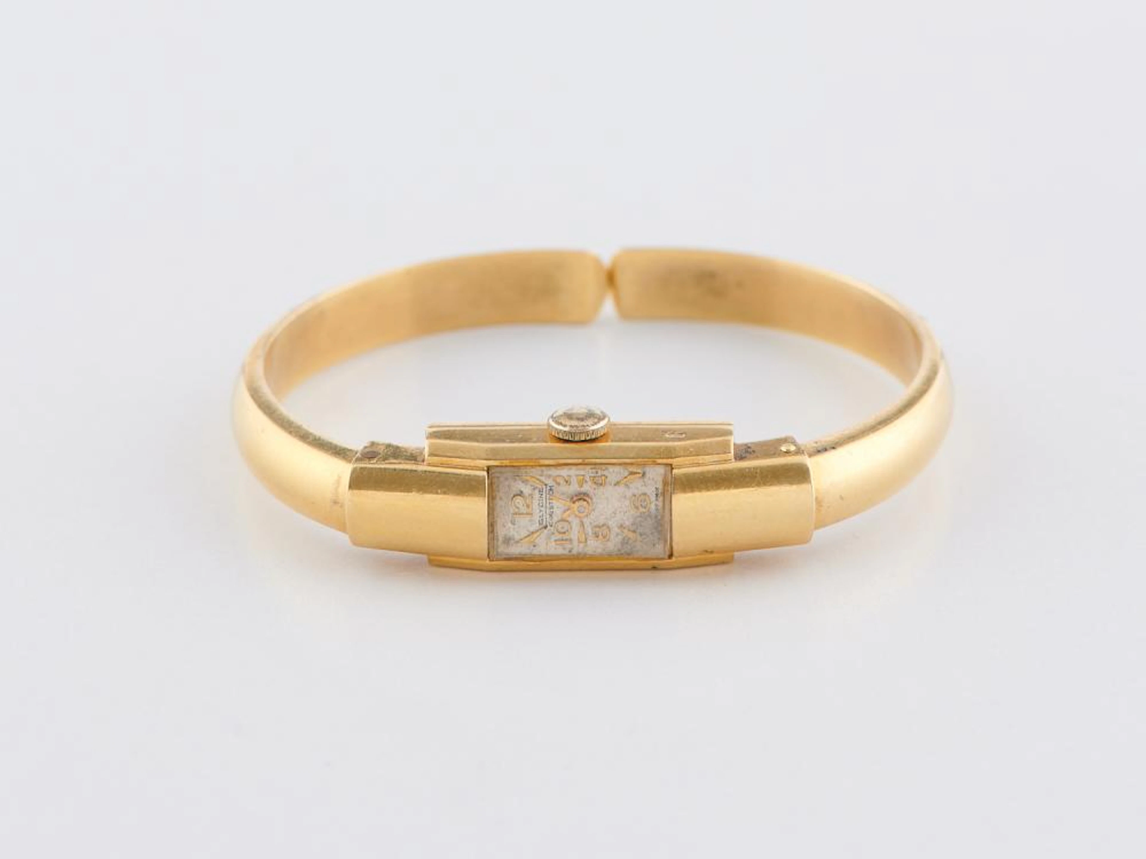 A HINGED GLYCINE BANGLE WRISTWATCH IN 18CT GOLD