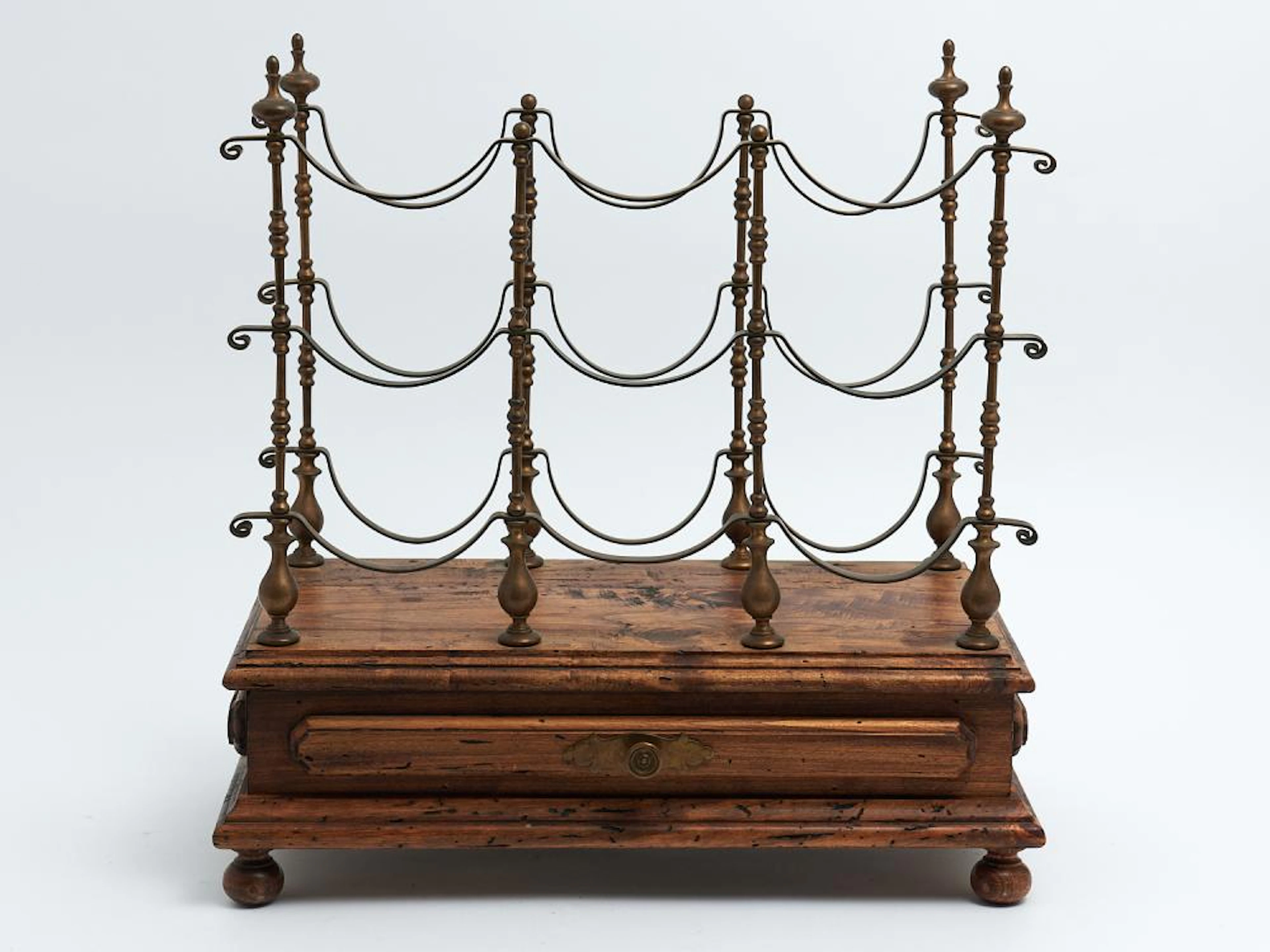 A VINTAGE WOODEN AND BRASS NINE BOTTLE WINE RACK WITH...