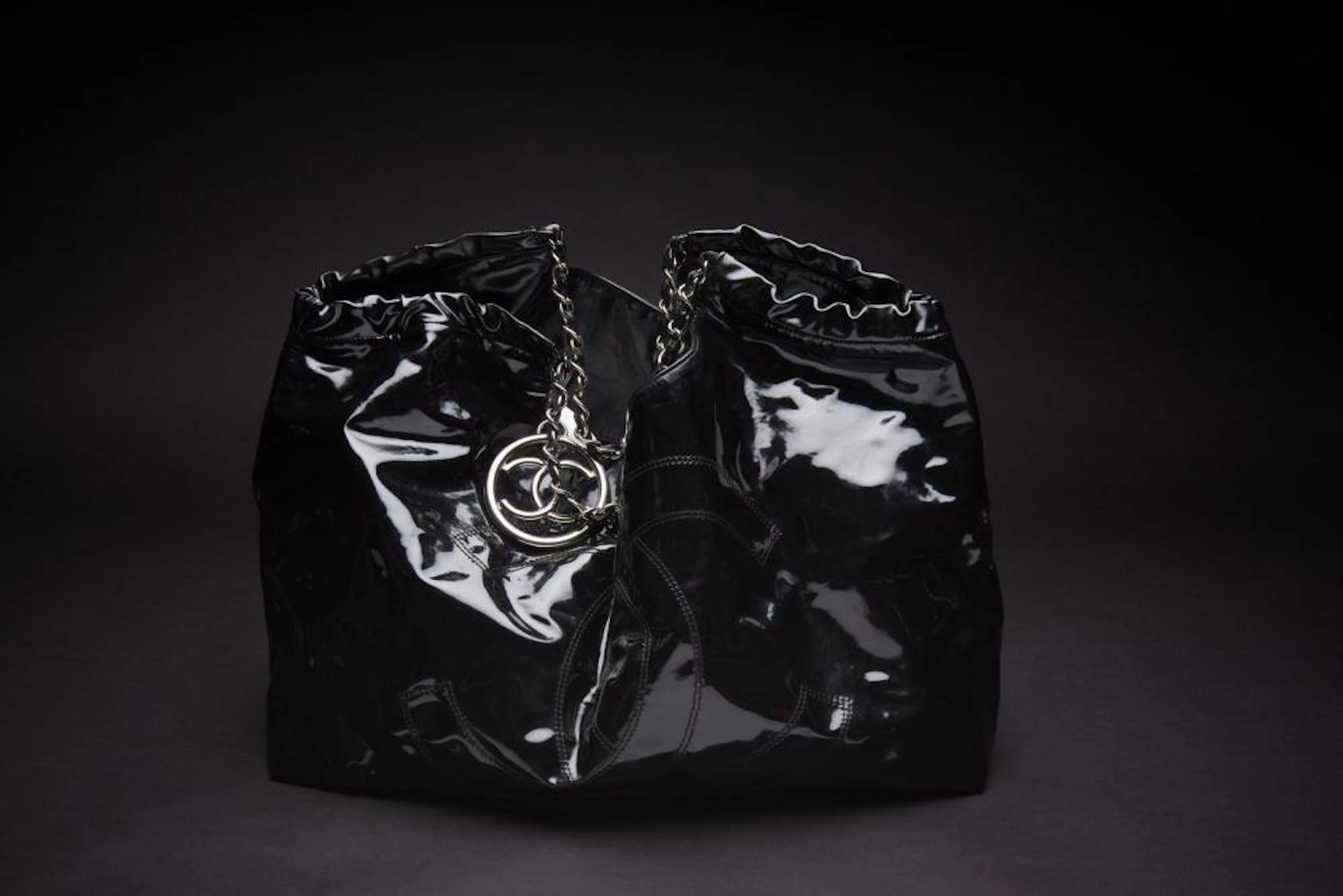 A COCO CABAS XL TOTE BY CHANEL-Styled in black vinyl with silver metal hardware