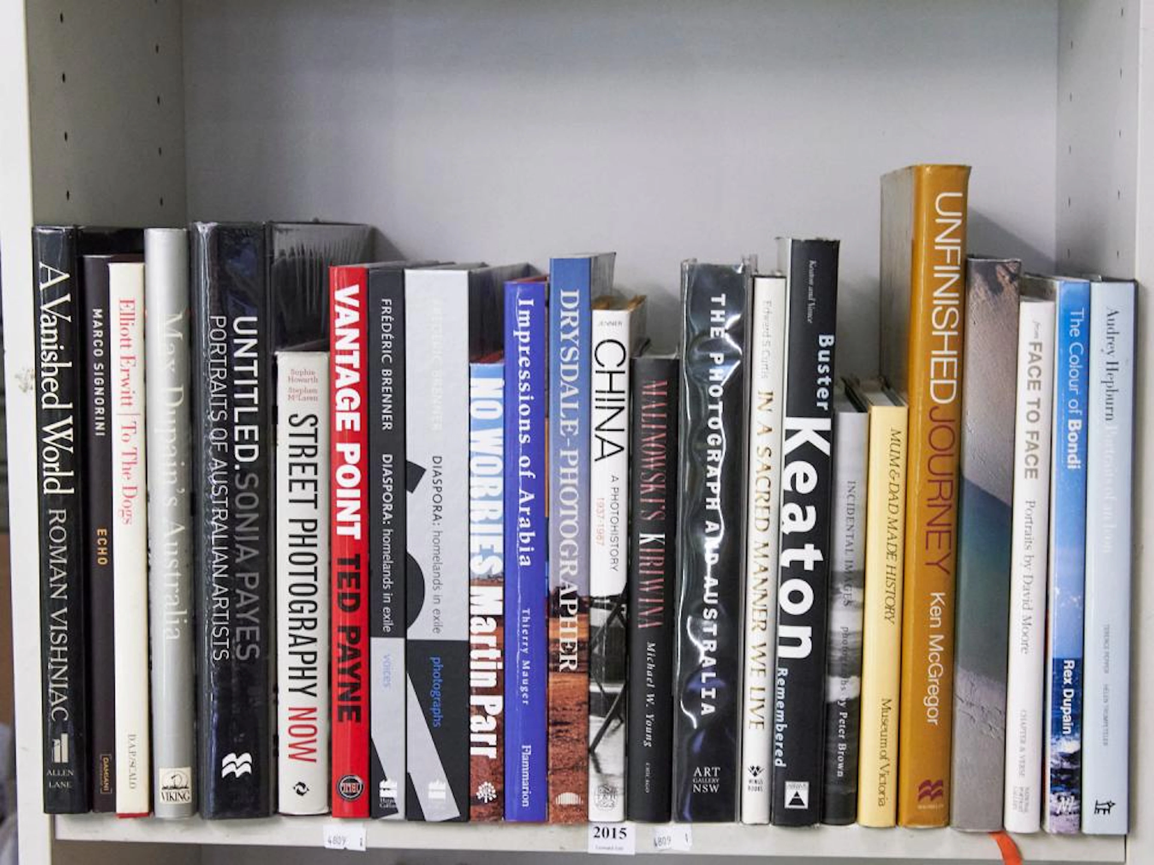 A SHELF OF PHOTOGRAPHY REFERENCE INCLUDING EDWARD CORTIS...