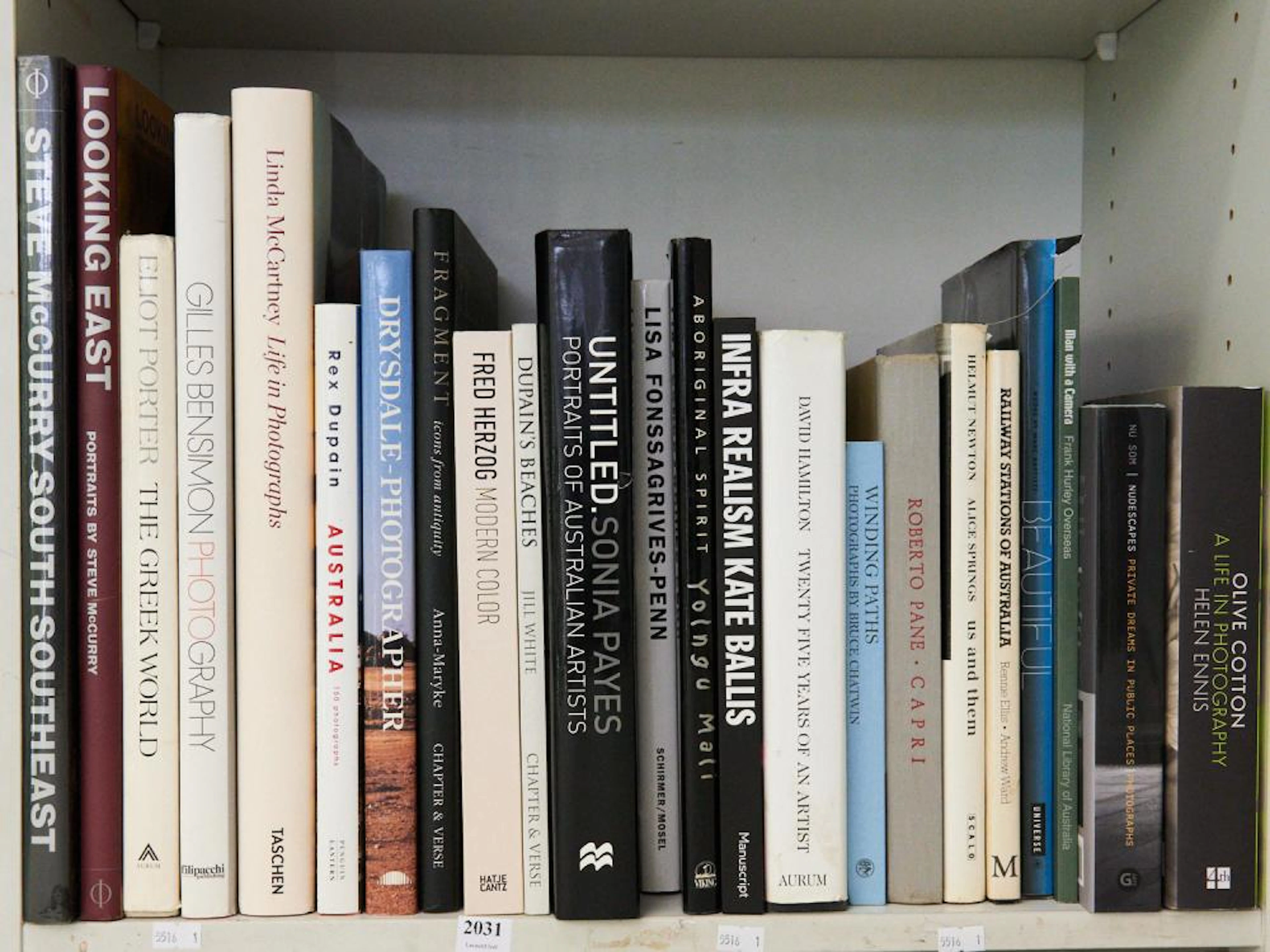 A SHELF OF PHOTOGRAPHIC REFERENCE INCLUDING LINDA...