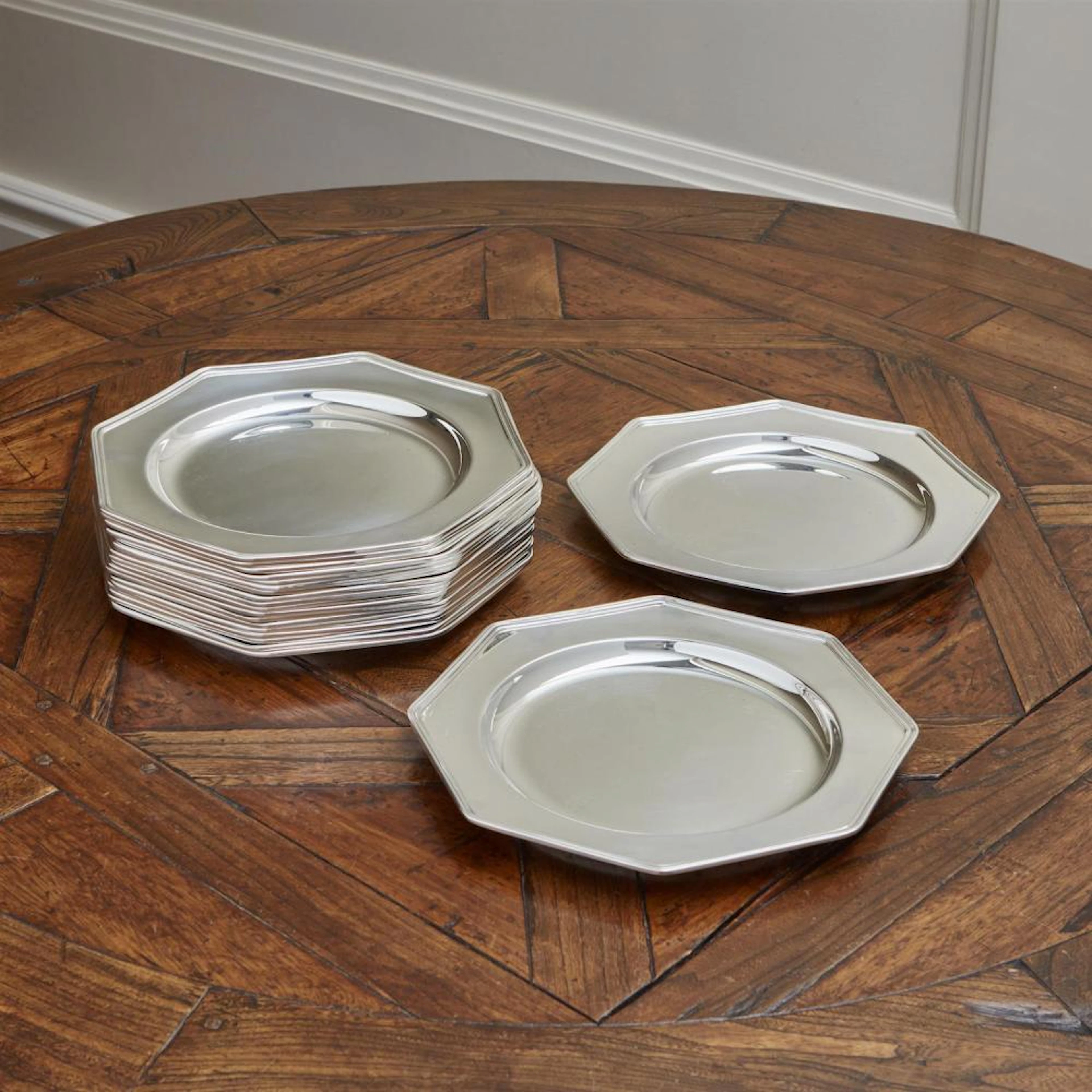 A SET OF TWENTY SILVER PLATE UNDER PLATES BY CHRISTOFLE