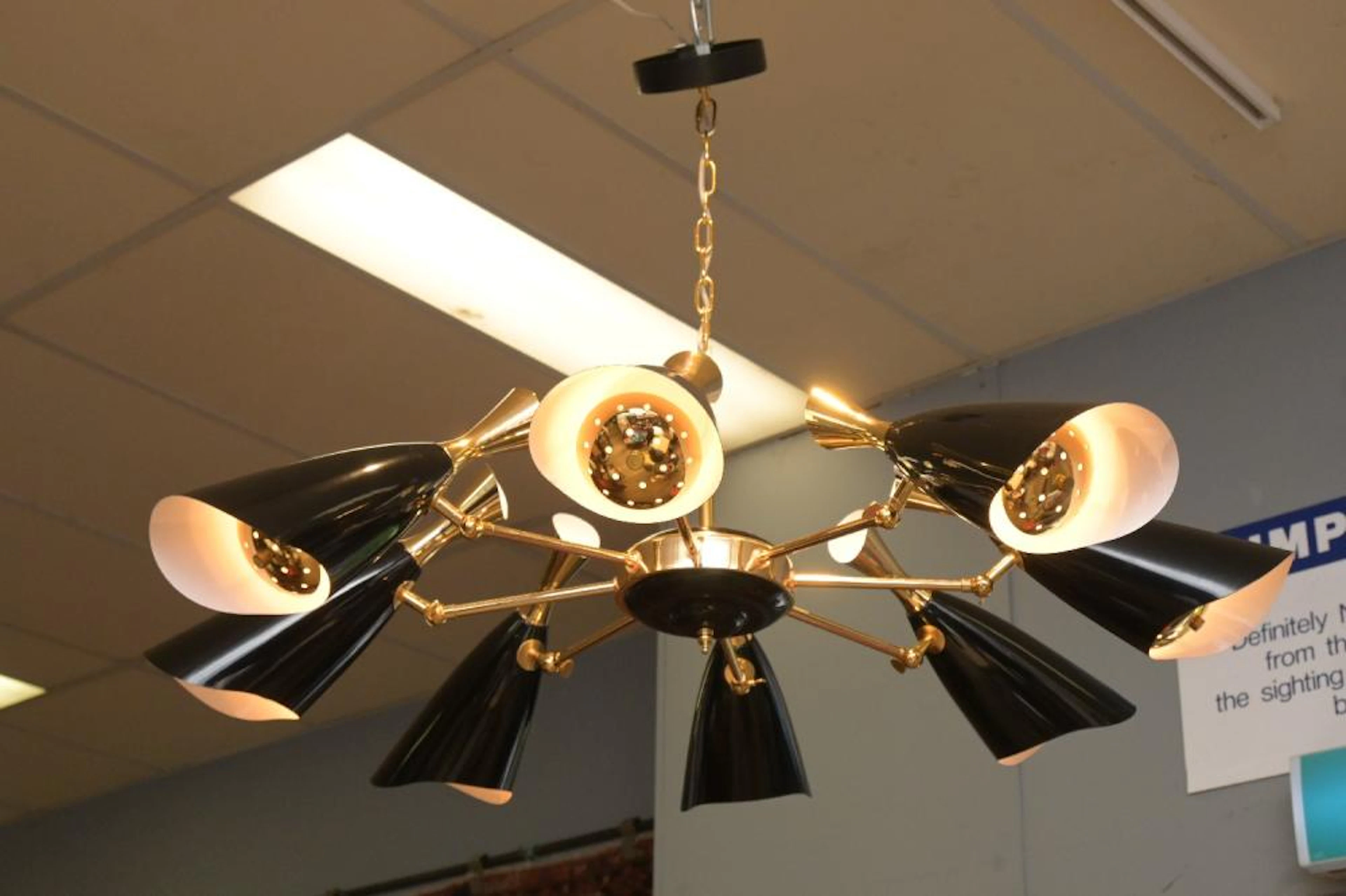 AN EIGHT BRANCH SIXTEEN GLOBE STILNOVO GOLD AND BLACK...
