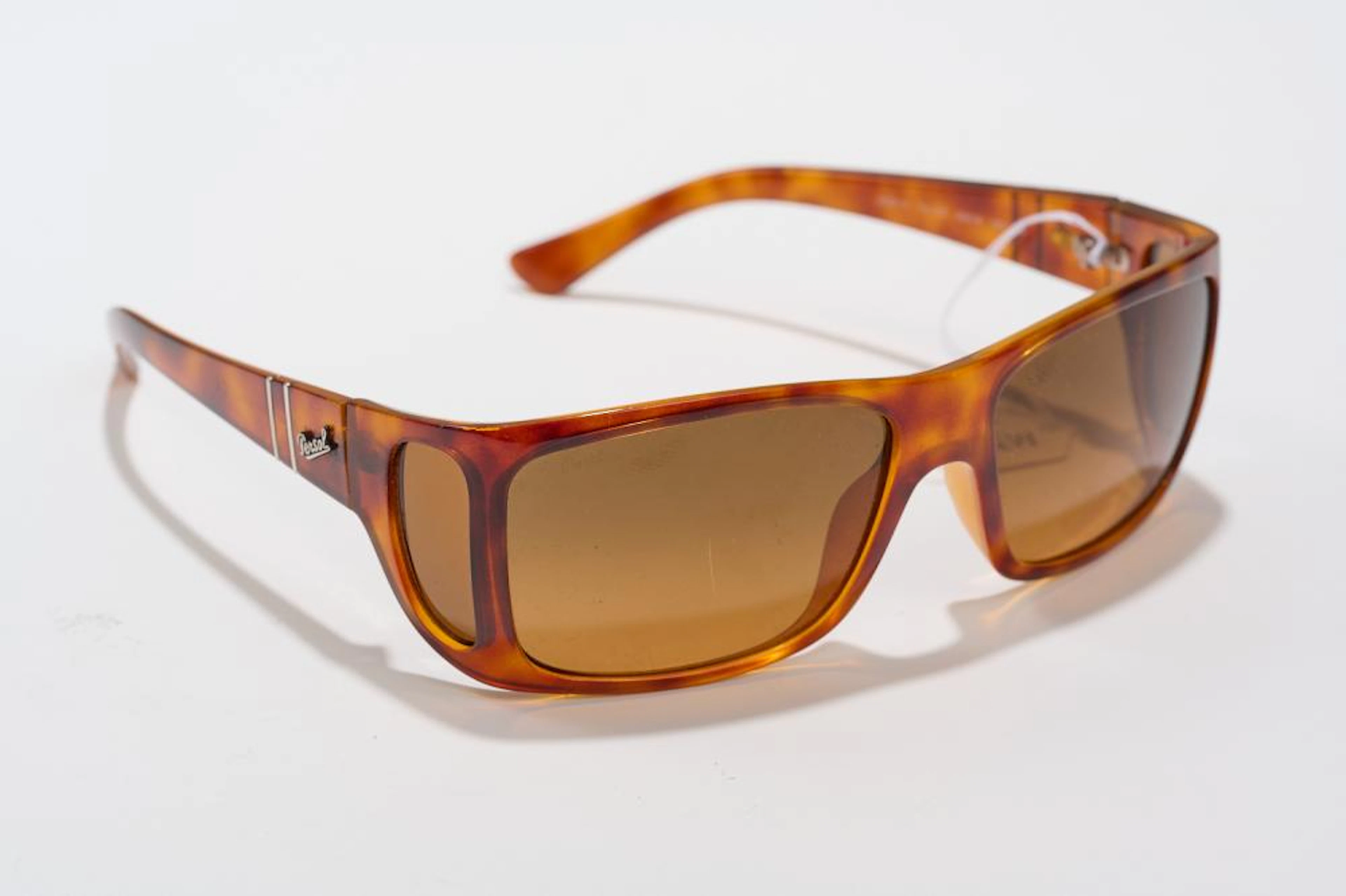 A PAIR OF SUNGLASSES BY PERSOL - Styled in tortoise...