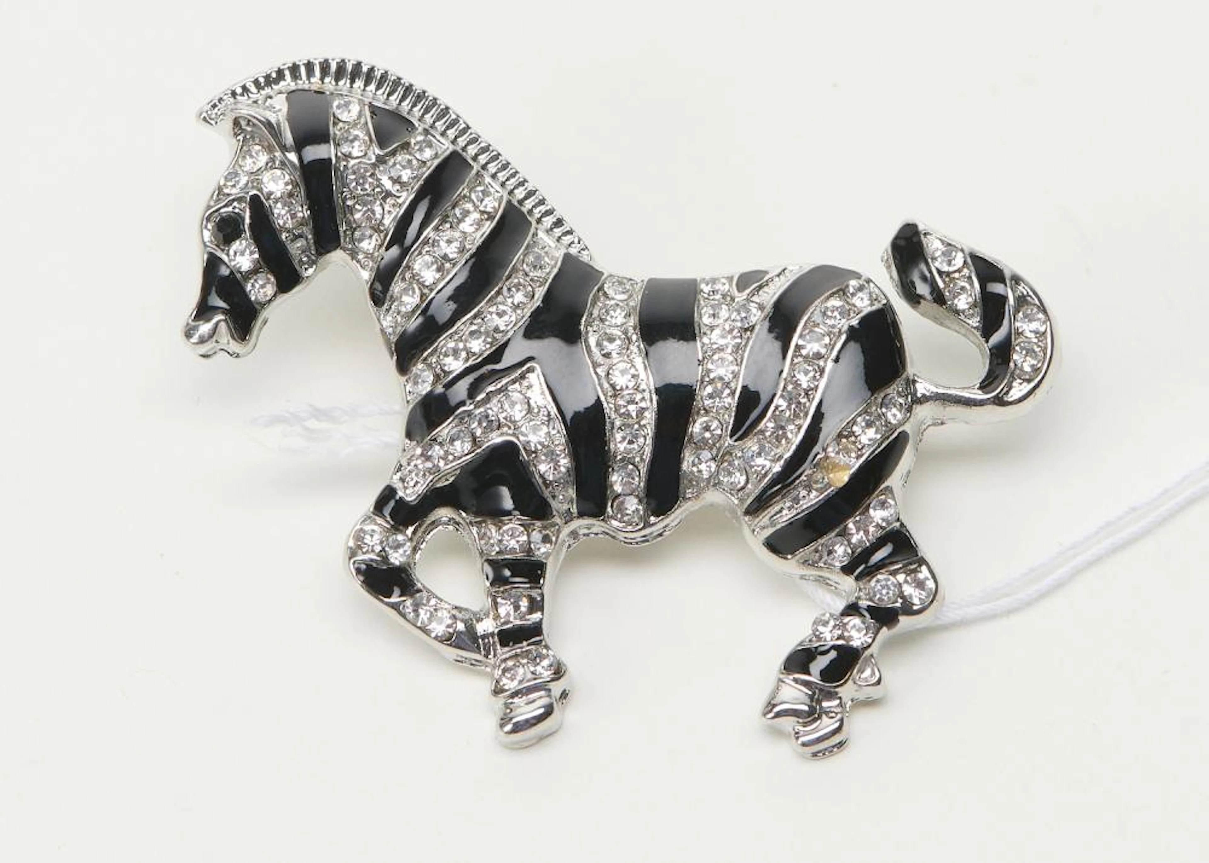 AN ENAMELLED AND RHINESTONE SET ZEBRA BROOCH