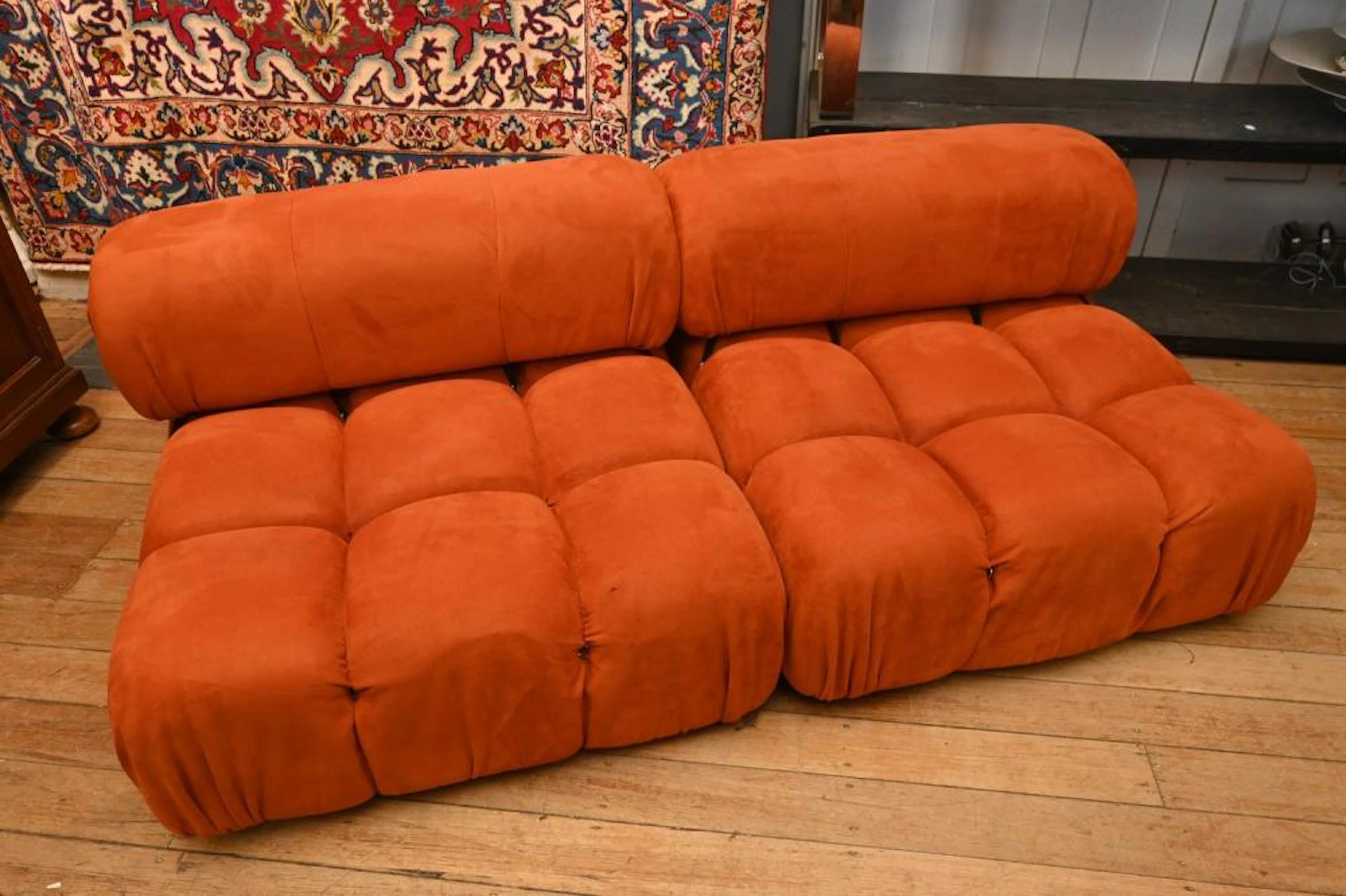 AN ORANGE TWO PIECE MODULAR SOFA IN THE STYLE OF B&B...