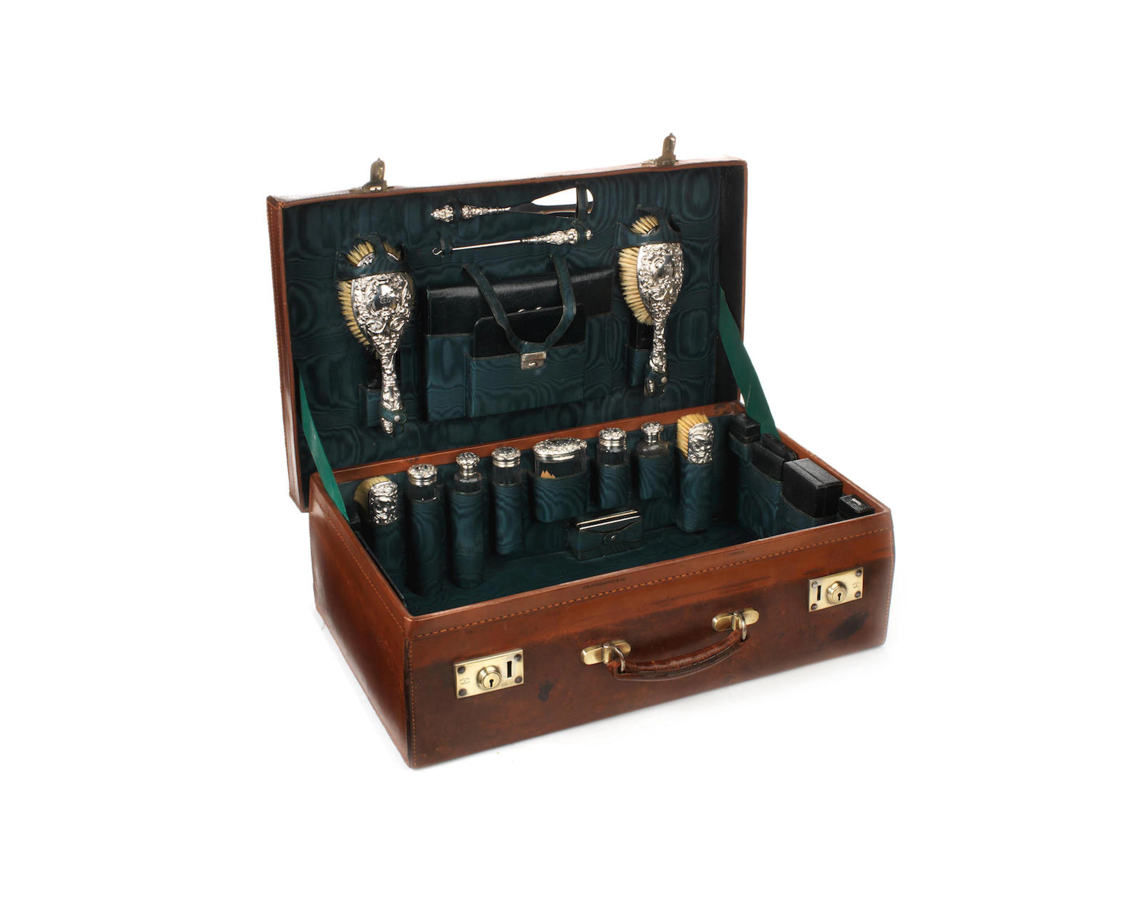 A leather-cased vanity set with sterling silver accessories, 1905,