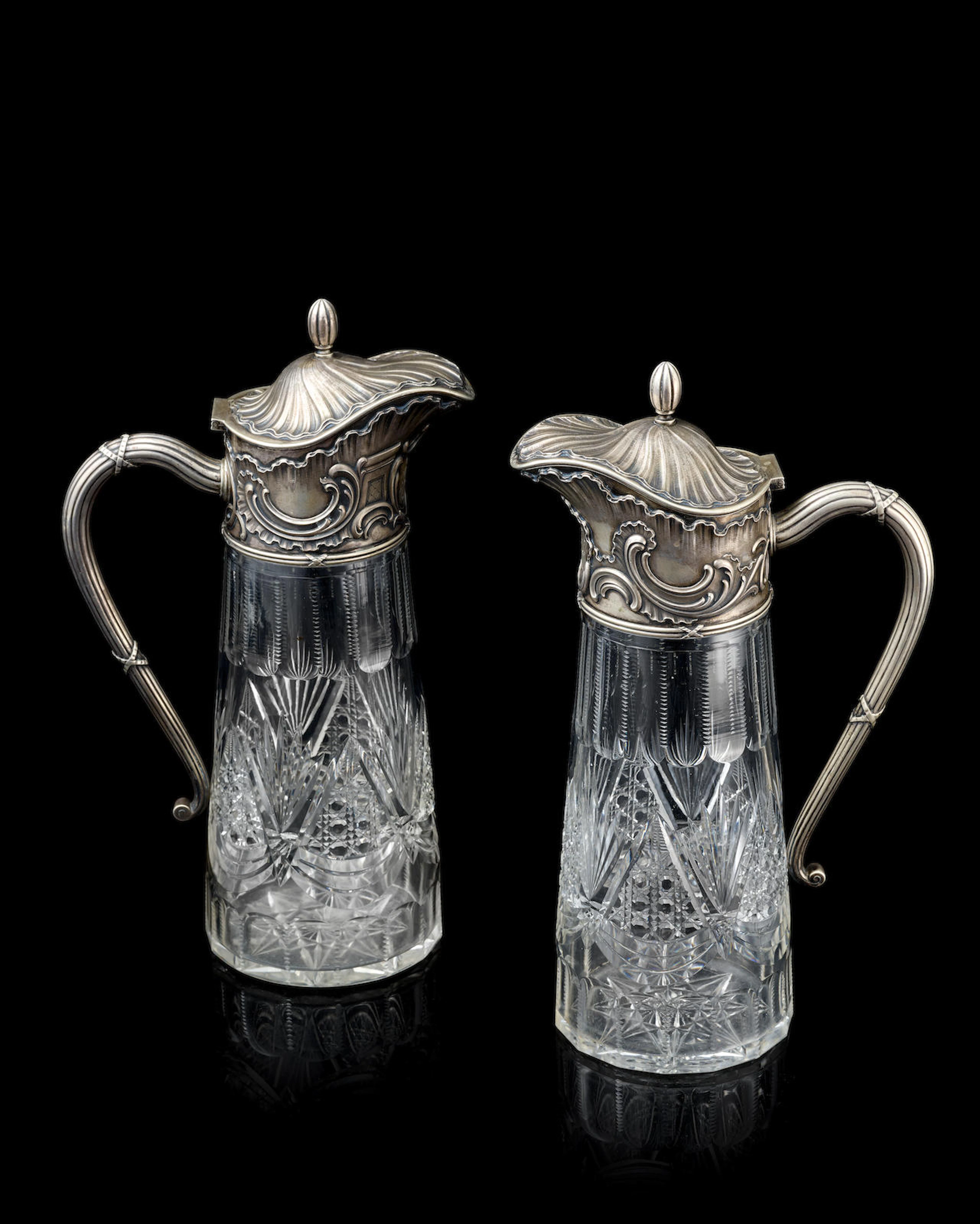 A pair of silver mounted cut glass claret jugs Fabergé, Moscow, 1898-1908