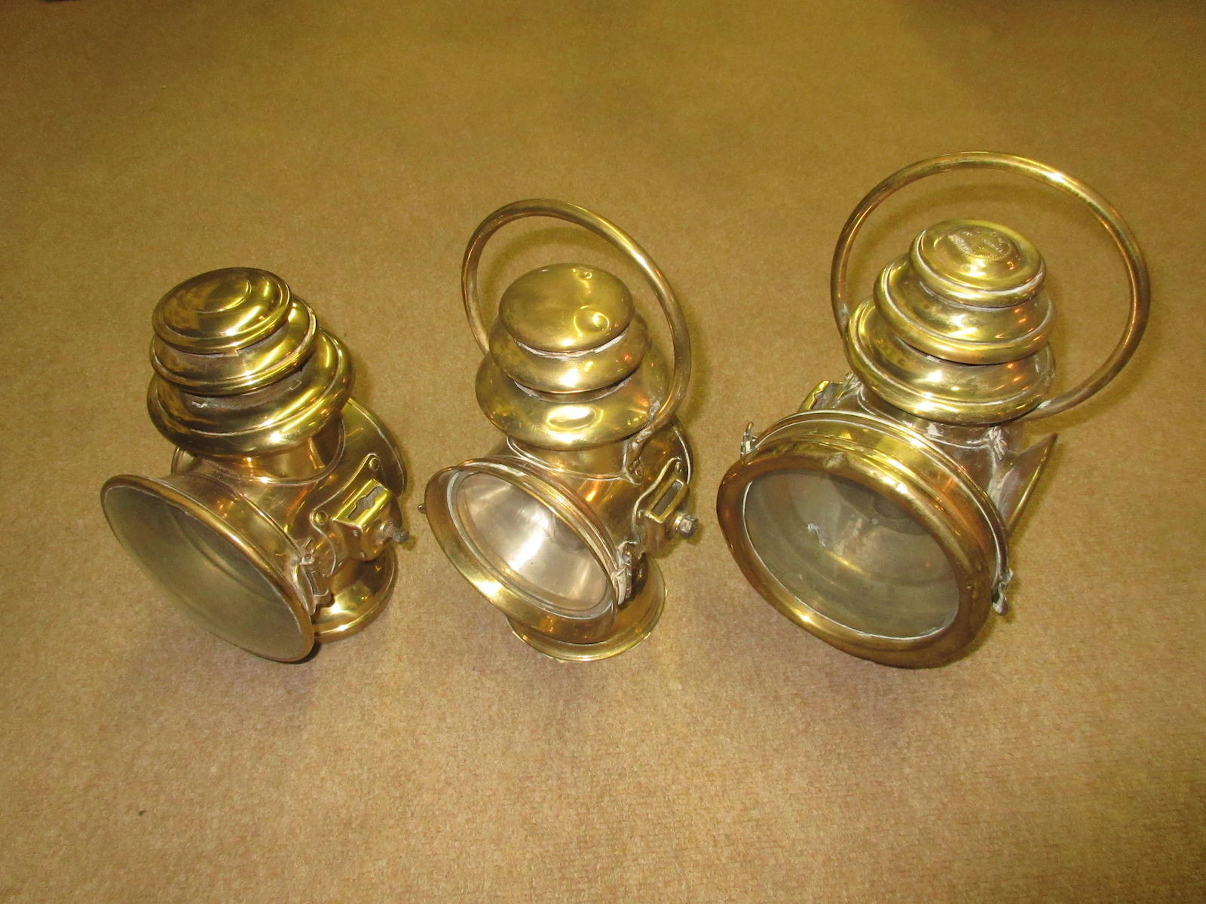 Three brass oil lamps,