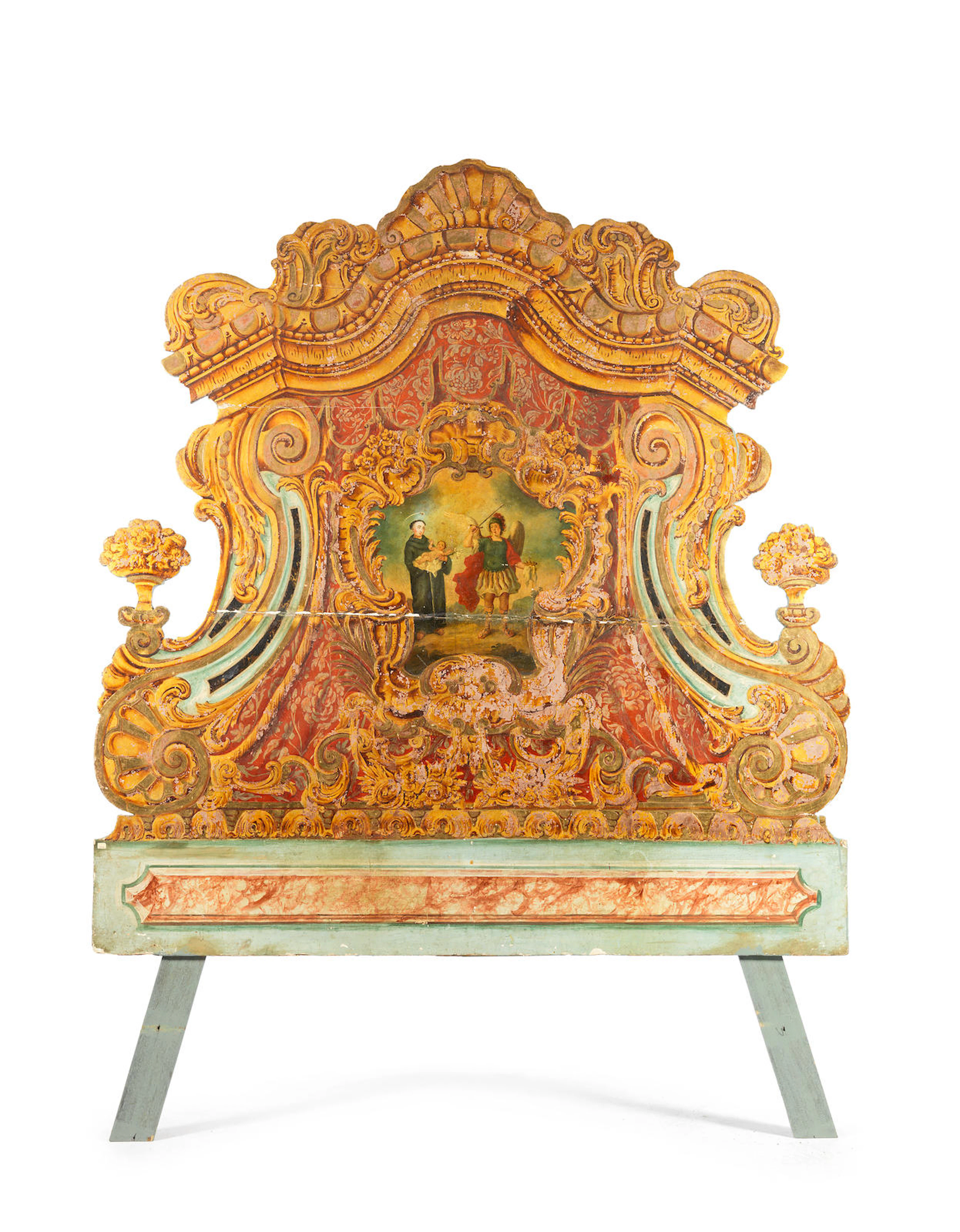 An 18th century carved, polychrome and gilt decorated bedhead