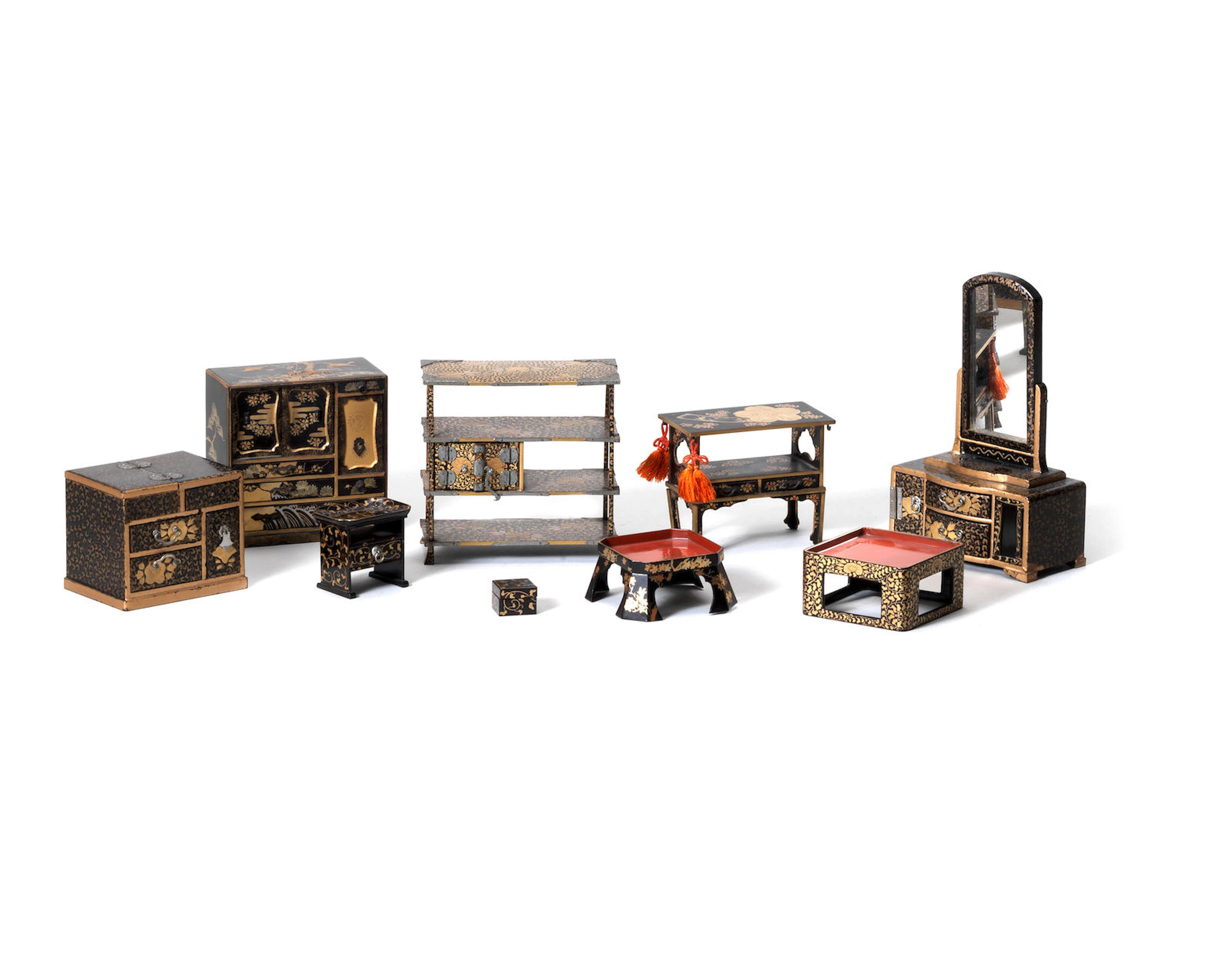 A selection of miniature black lacquer furniture