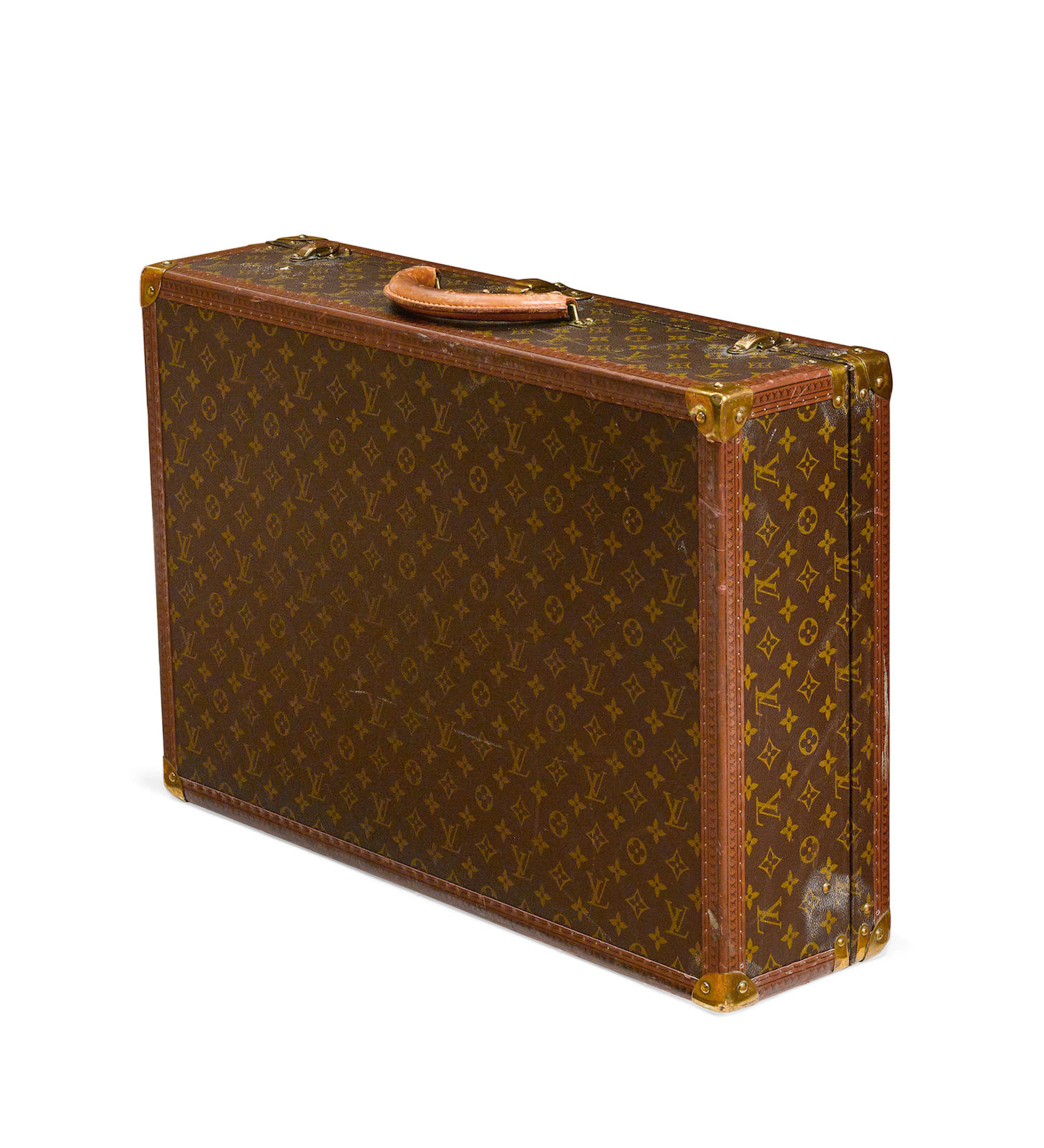 A Louis Vuitton Alzer hard sided suitcase numbered 984610 circa 1980