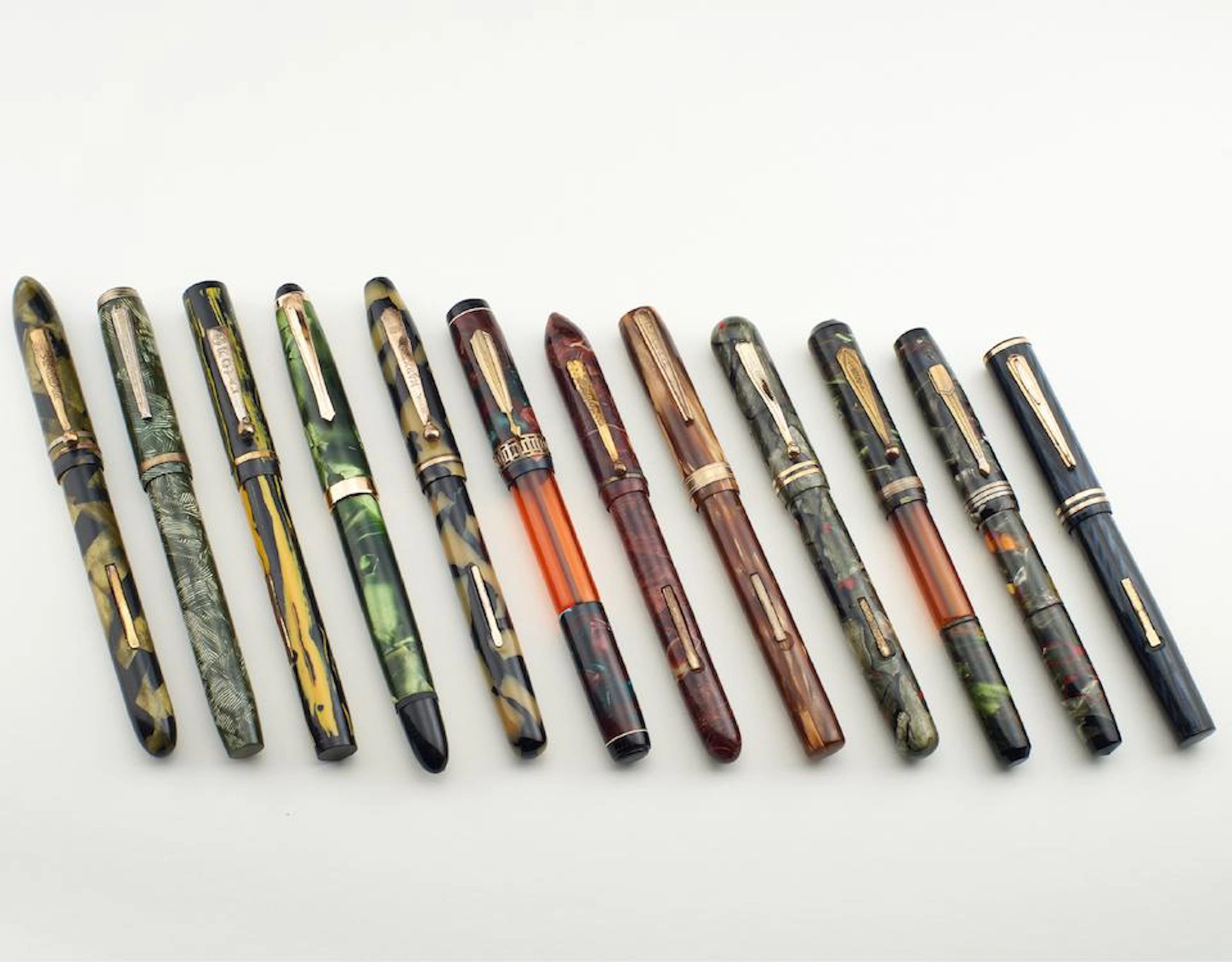 A Group of Twelve Assorted Marble Effect Fountain Pens