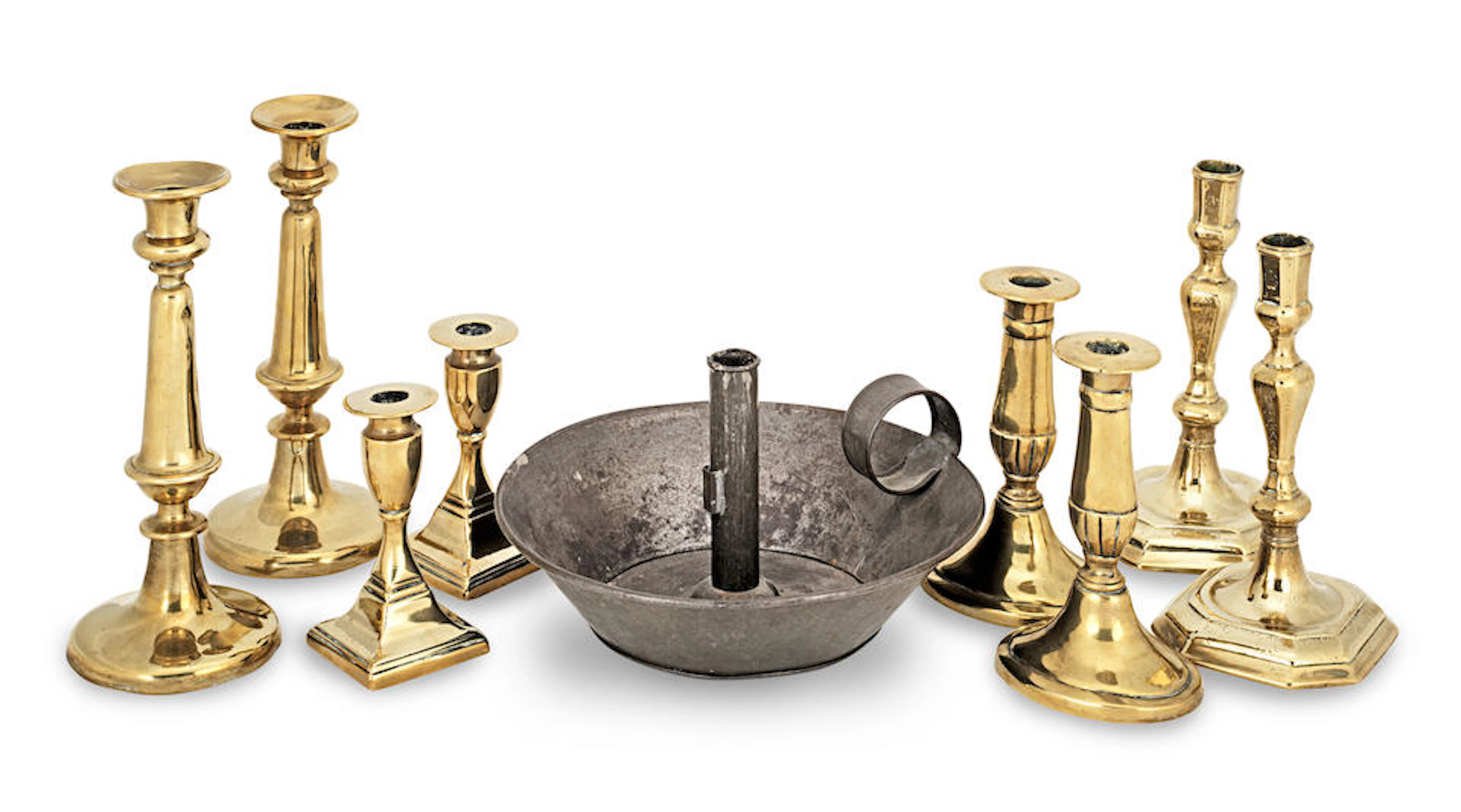 A pair of Queen Anne/George I engraved brass socket candelsticks, circa 1715 (9)