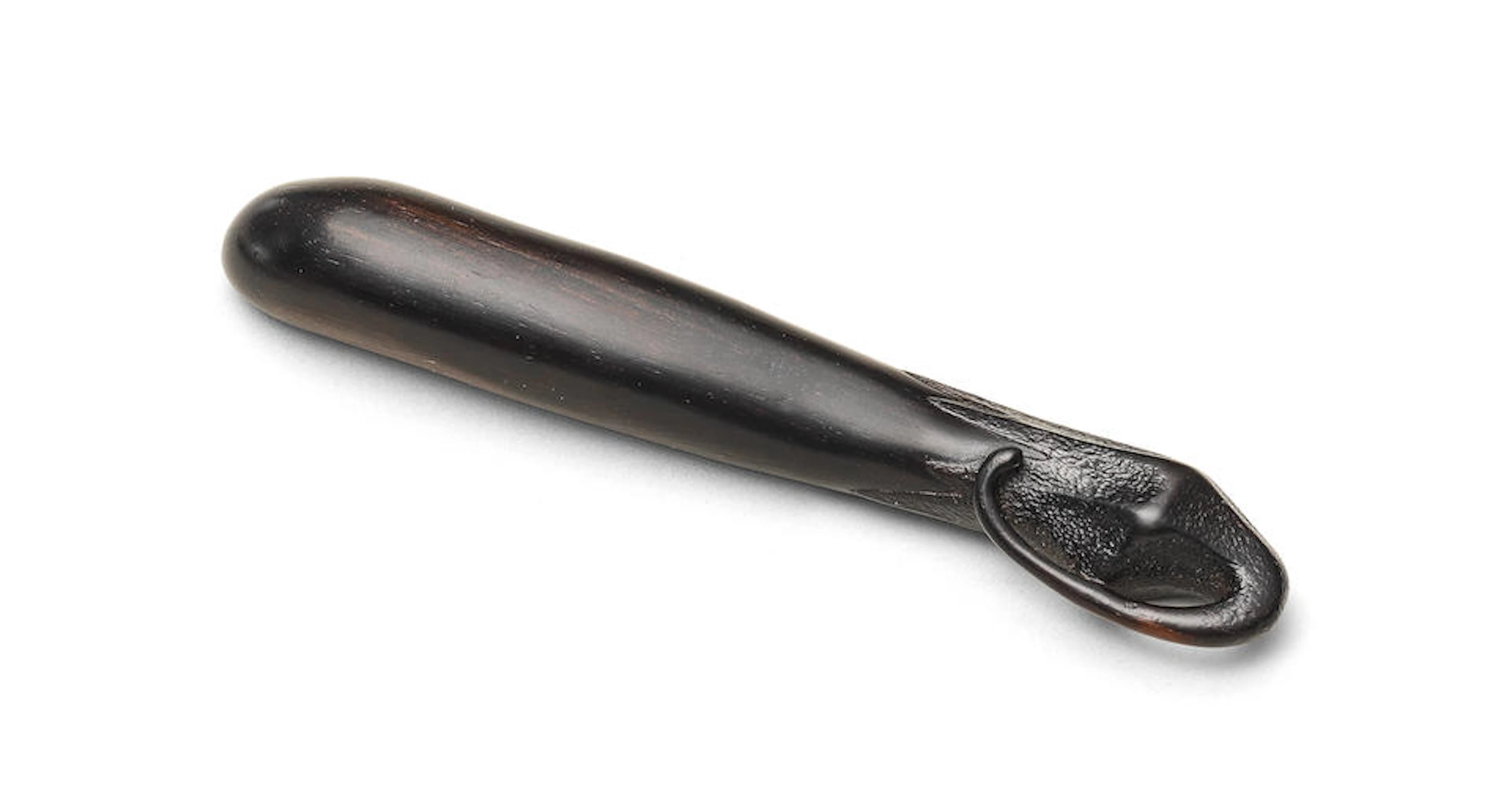 A kurogaki (black persimmon) wood sashi netsuke of an...