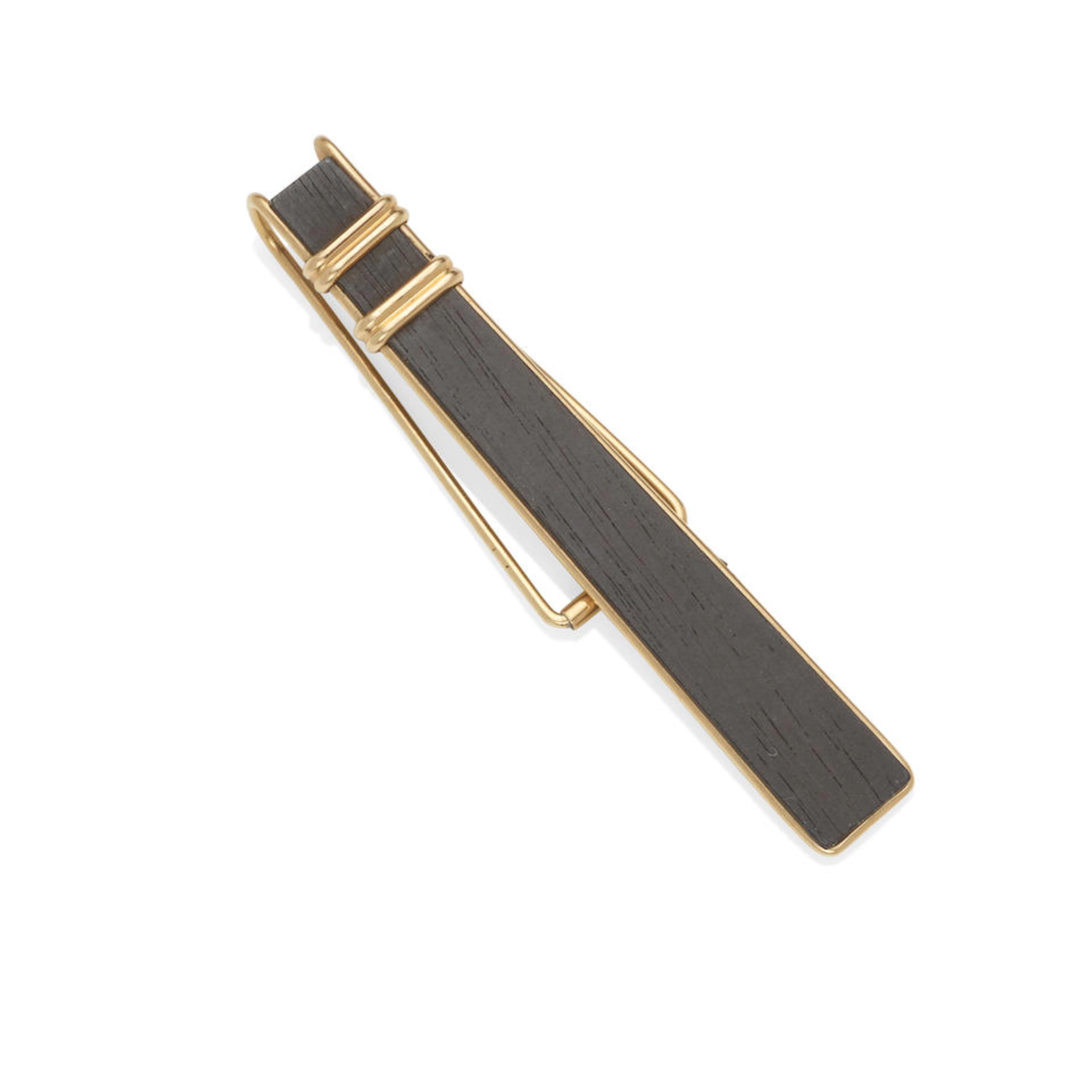 ALLAN ADLER: A 14K ROSE GOLD AND EBONY TIE CLIP