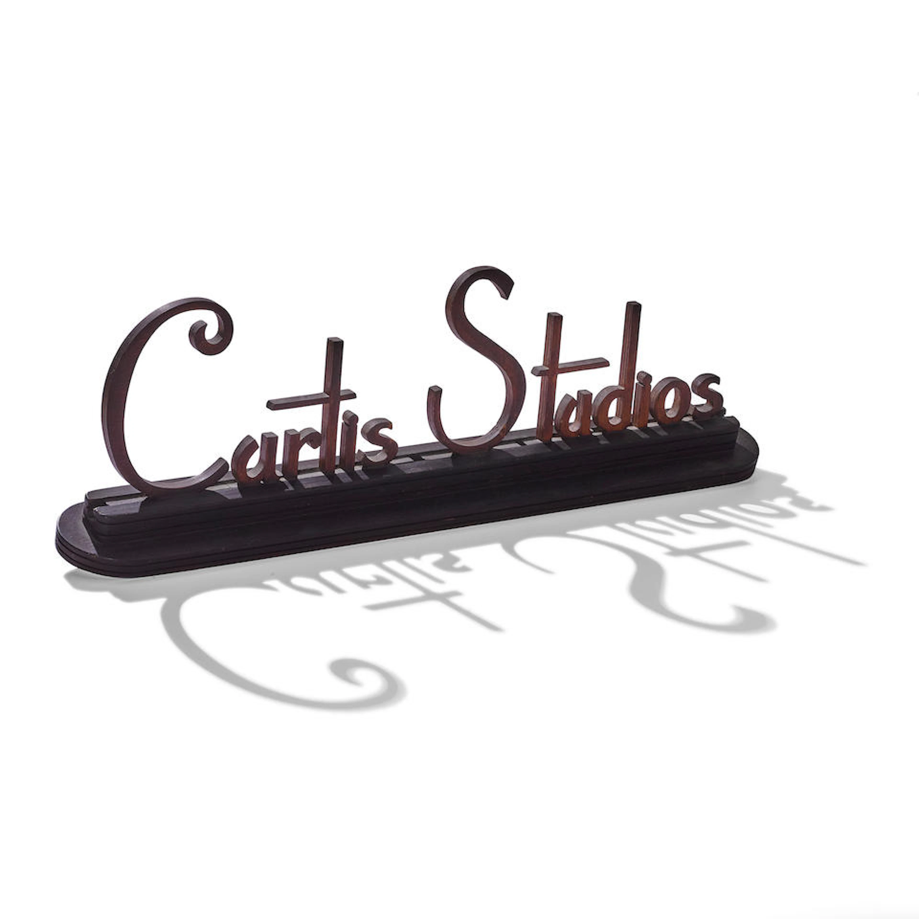 A CURTIS STUDIOS ART DECO CARVED OAK BUSINESS SIGN