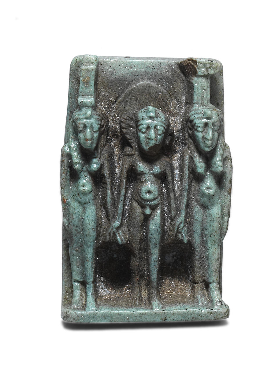 An Egyptian pale green glazed faience triad amuletic plaque