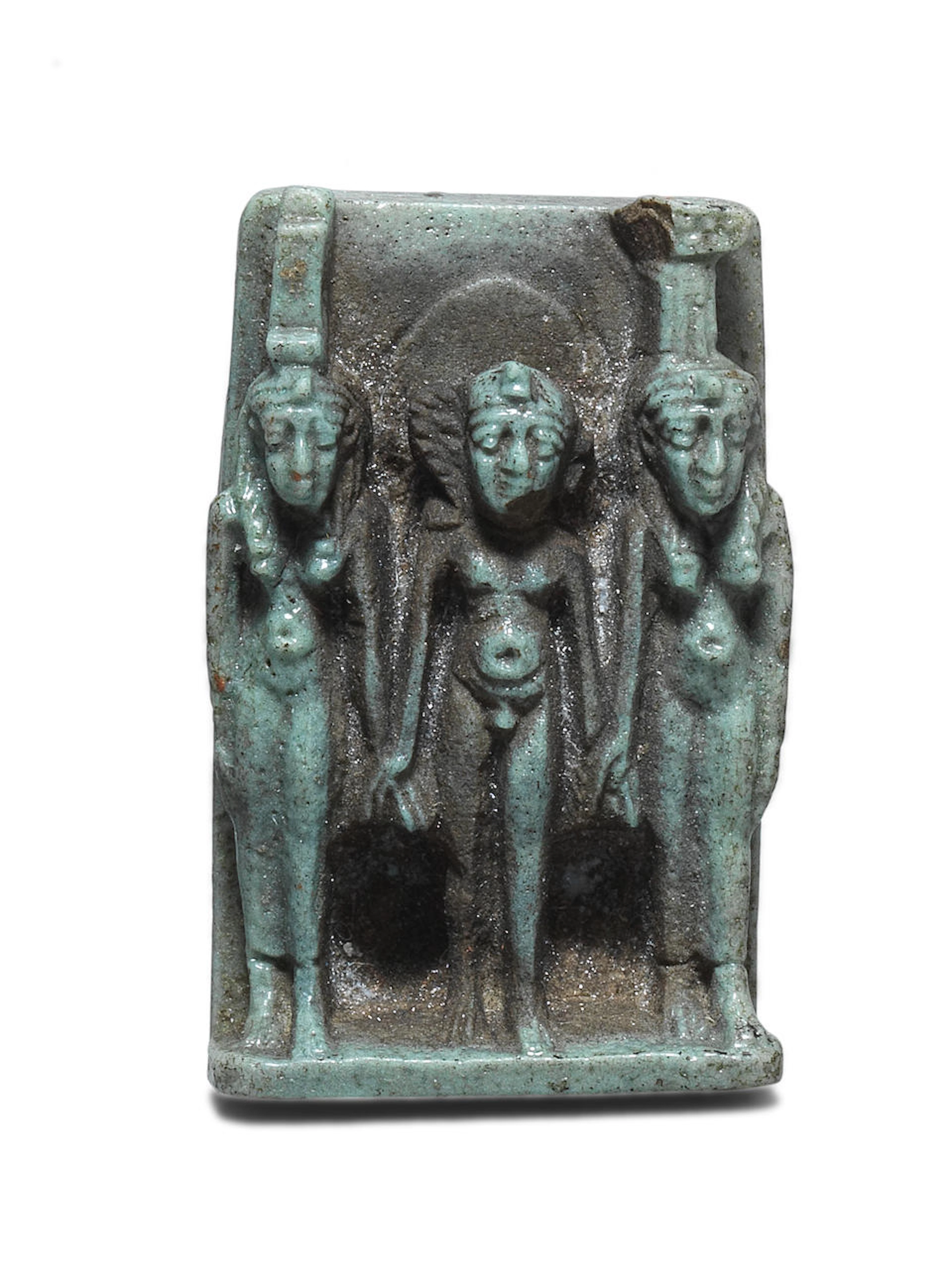 An Egyptian pale green glazed faience triad amuletic plaque