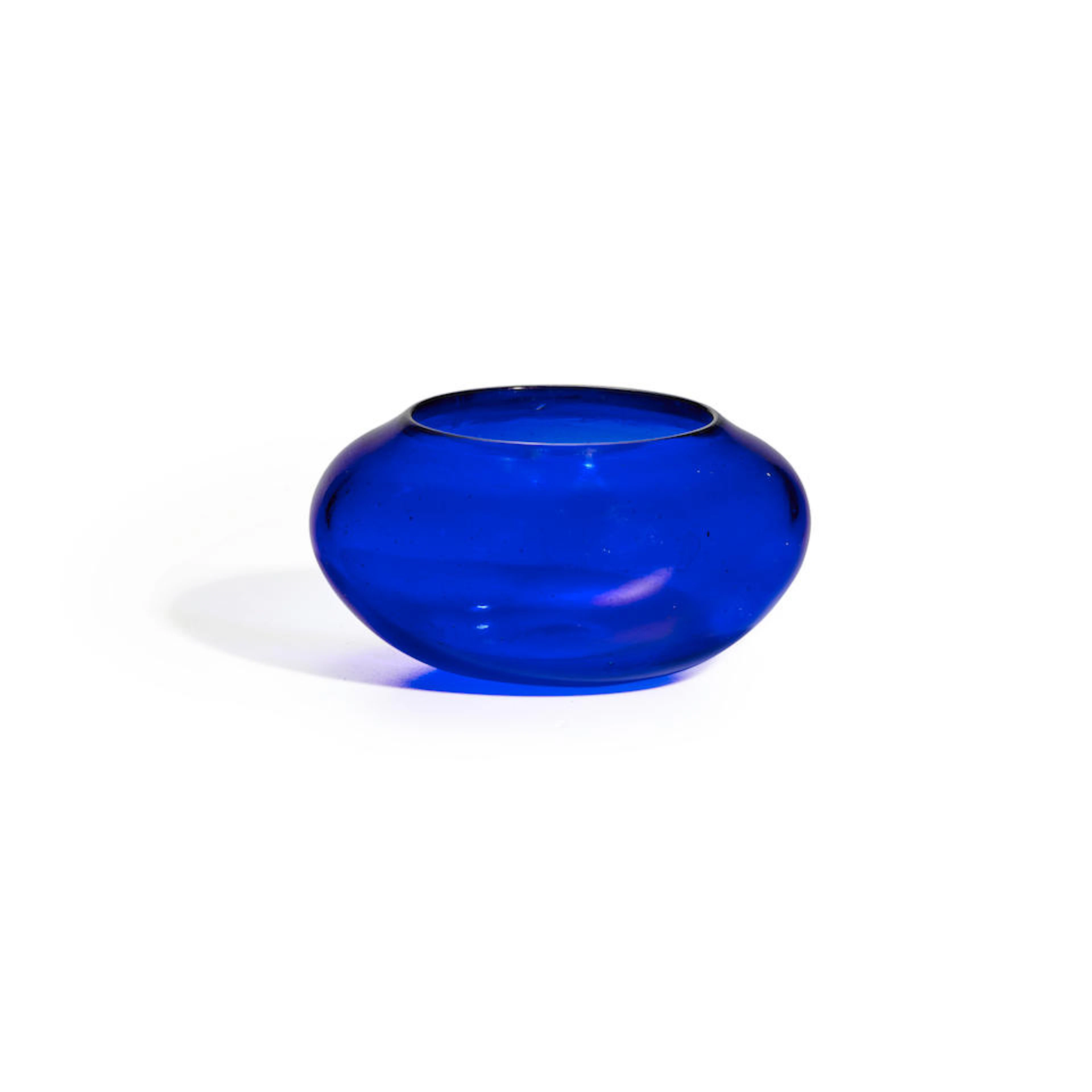 AN ELEGANT TRANSPARENT DEEP BLUE GLASS COMPRESSED-FORM...
