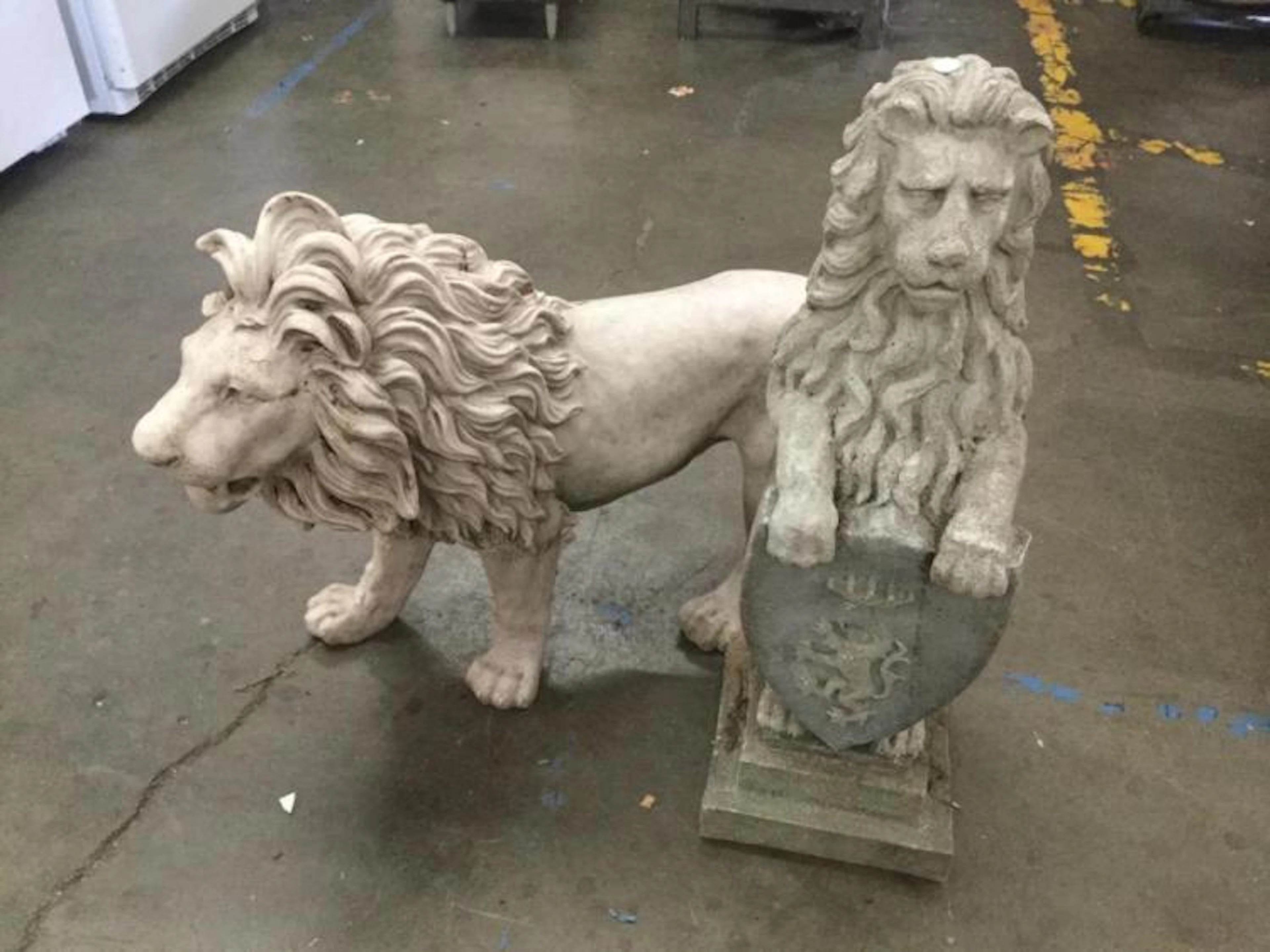 Two concrete yard art lions